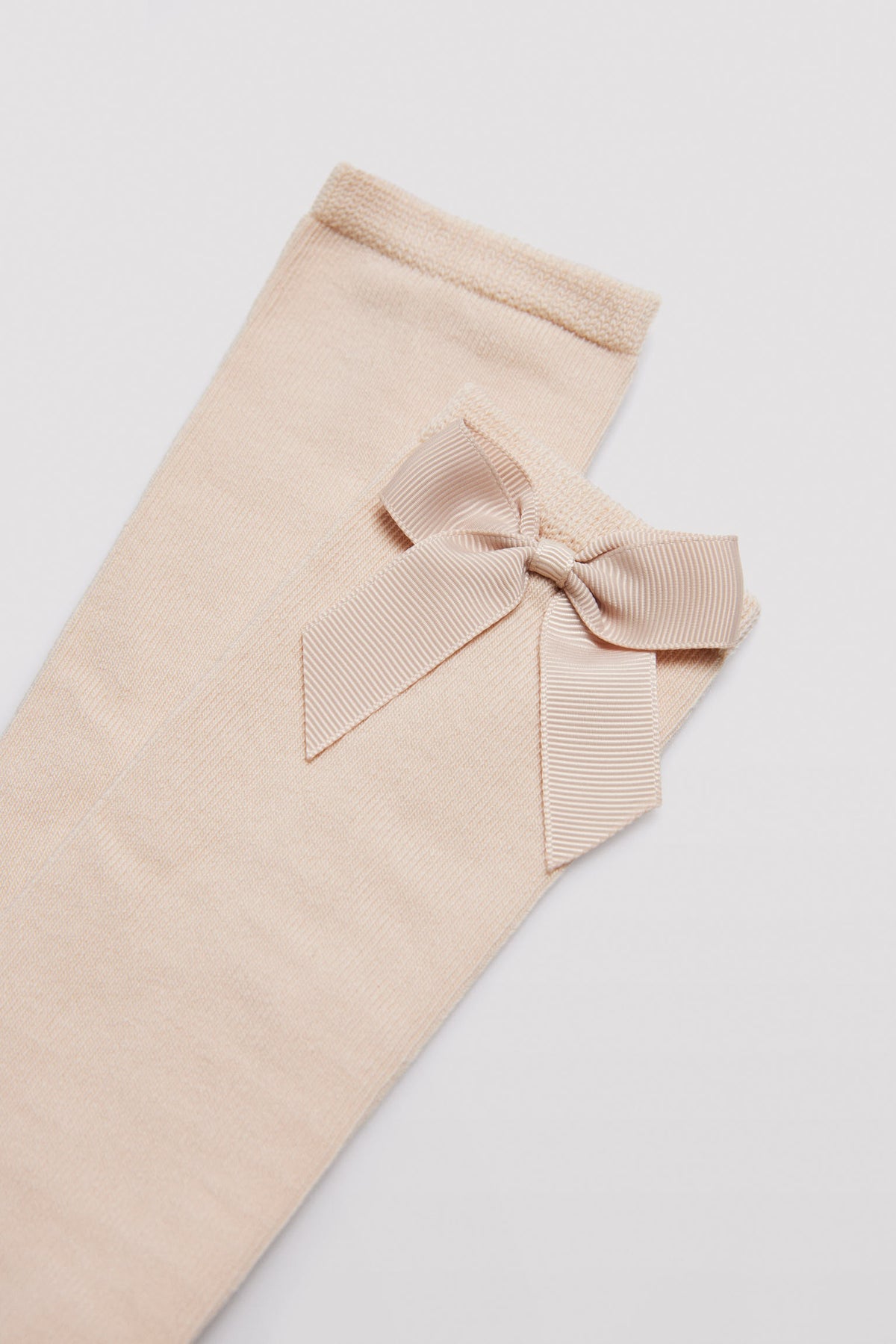 Long children's sock with beige bow detail