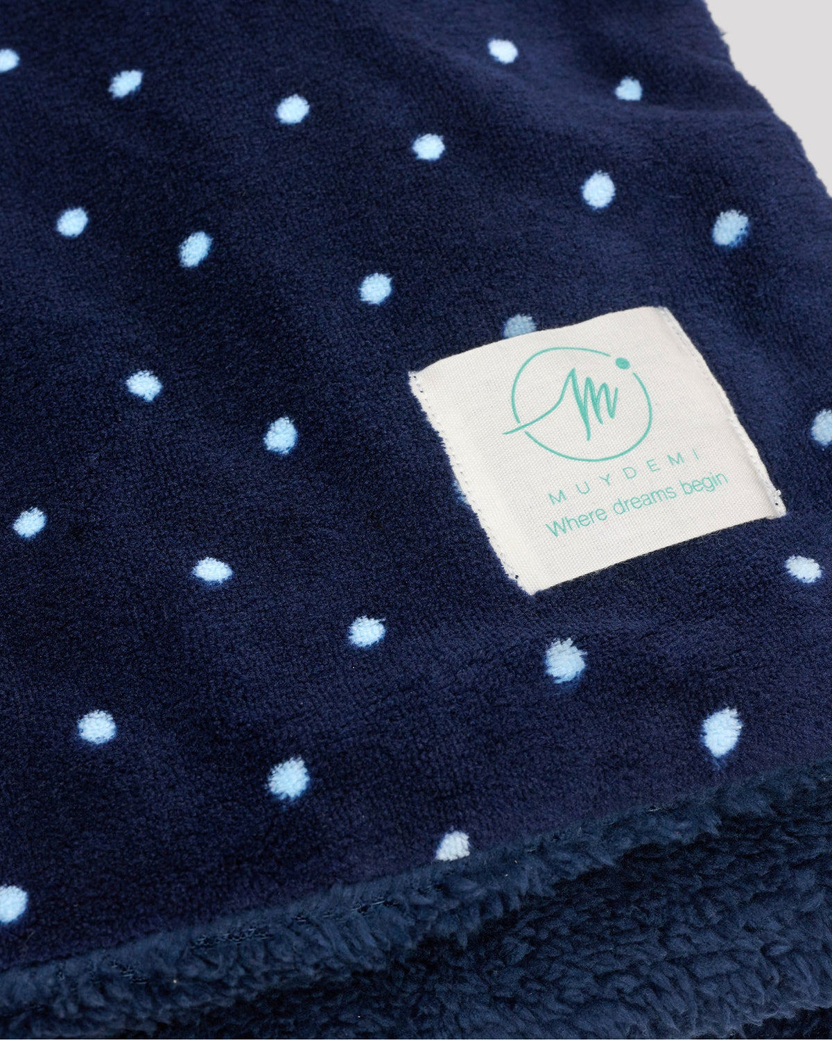 Navy polka-dot coral fleece and shearling blanket