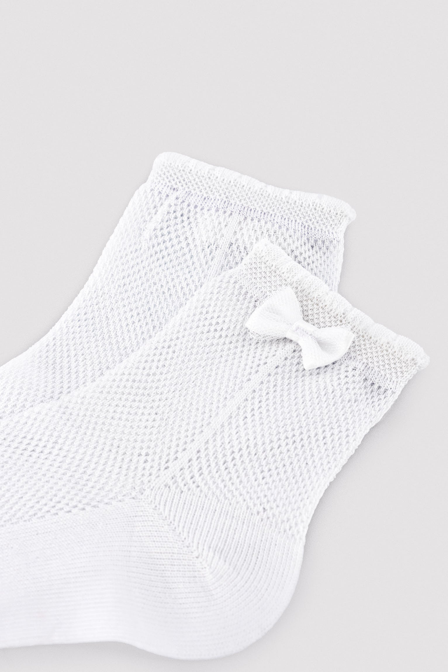 Children's openwork socks with white bow detail