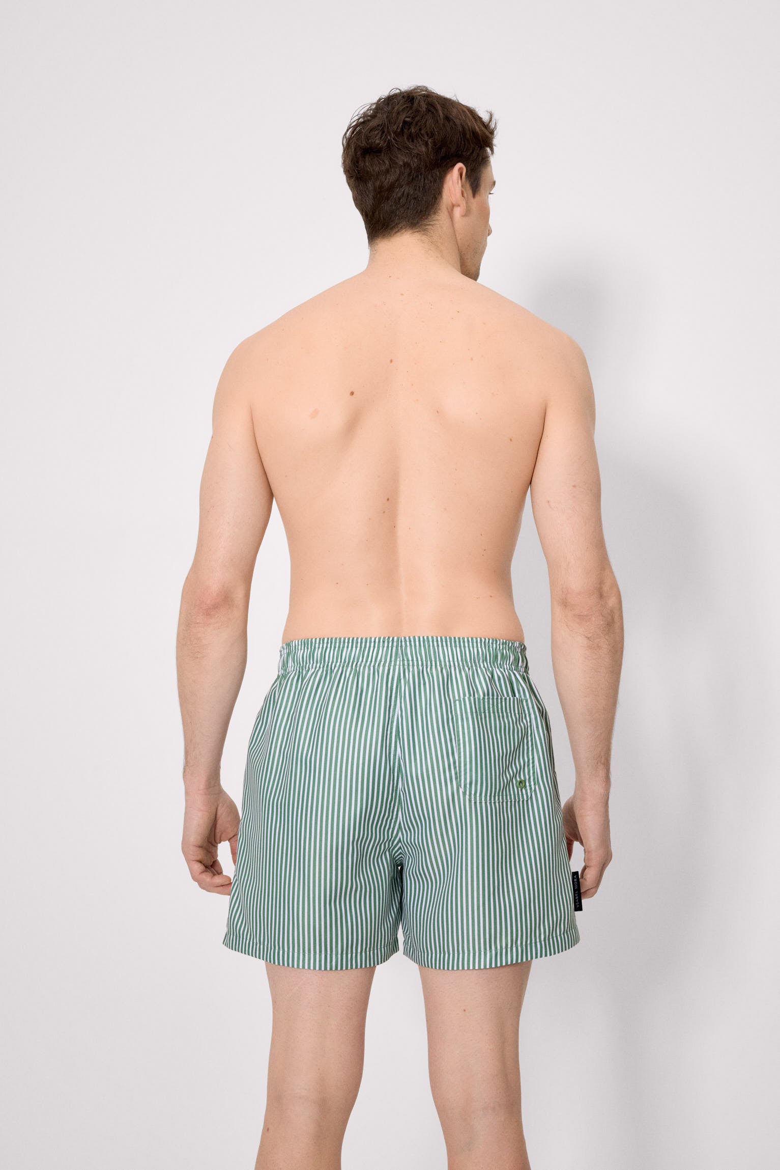 Medium-length swimsuit with green striped print