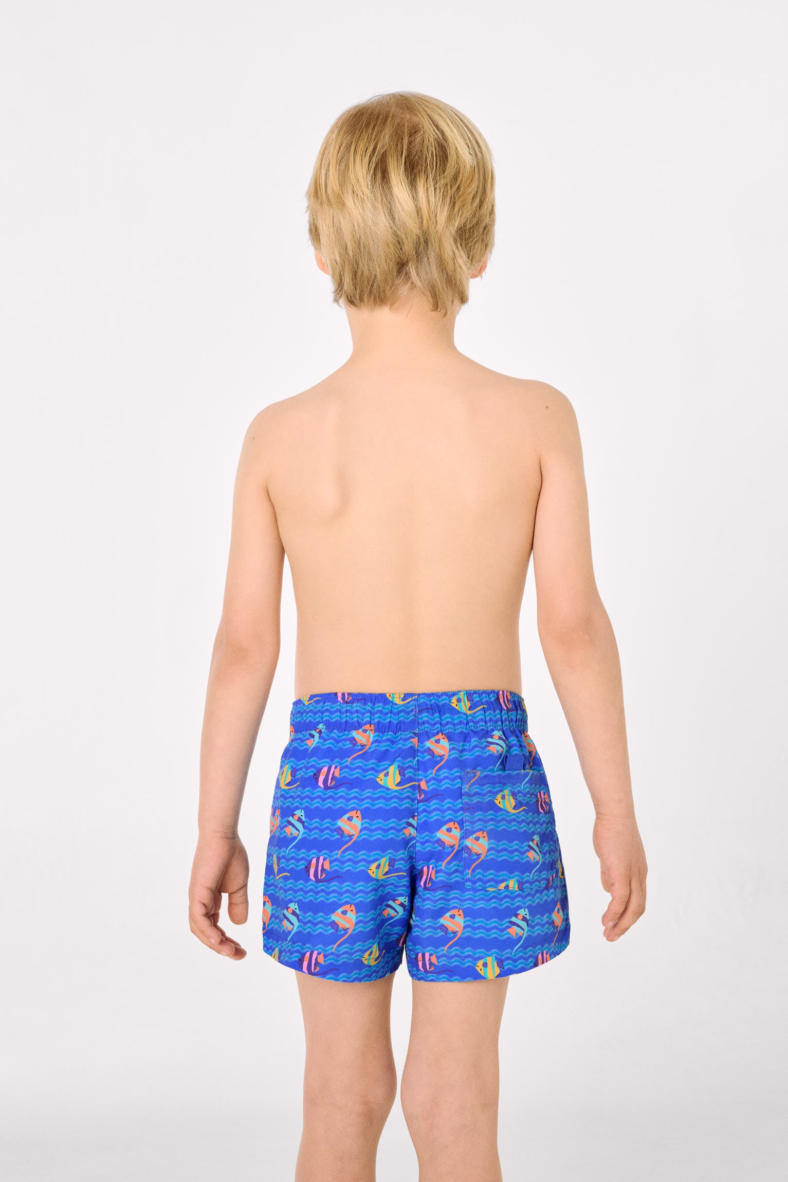 Boys' short swim trunks with a multicolored tropical fish print