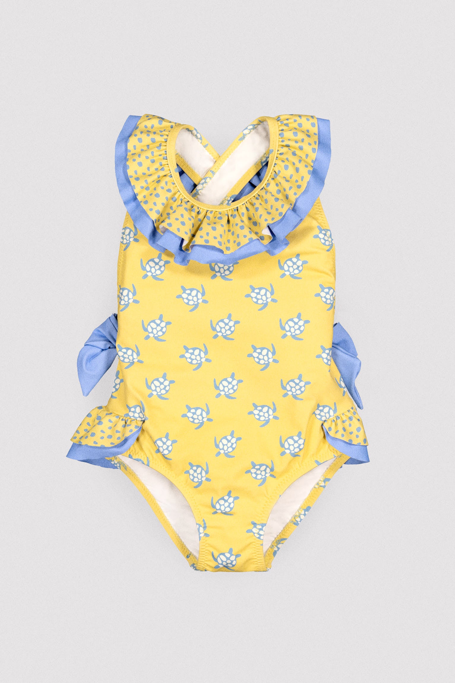 Girls' swimsuit with ruffle details and bows, turtle print