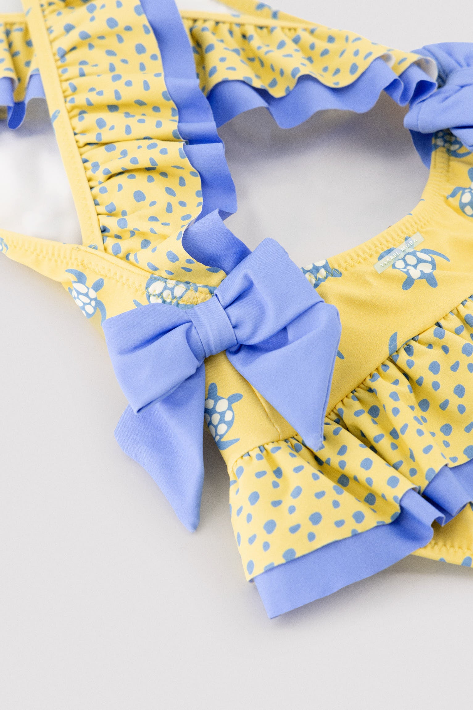 Girls' swimsuit with ruffle details and bows, turtle print