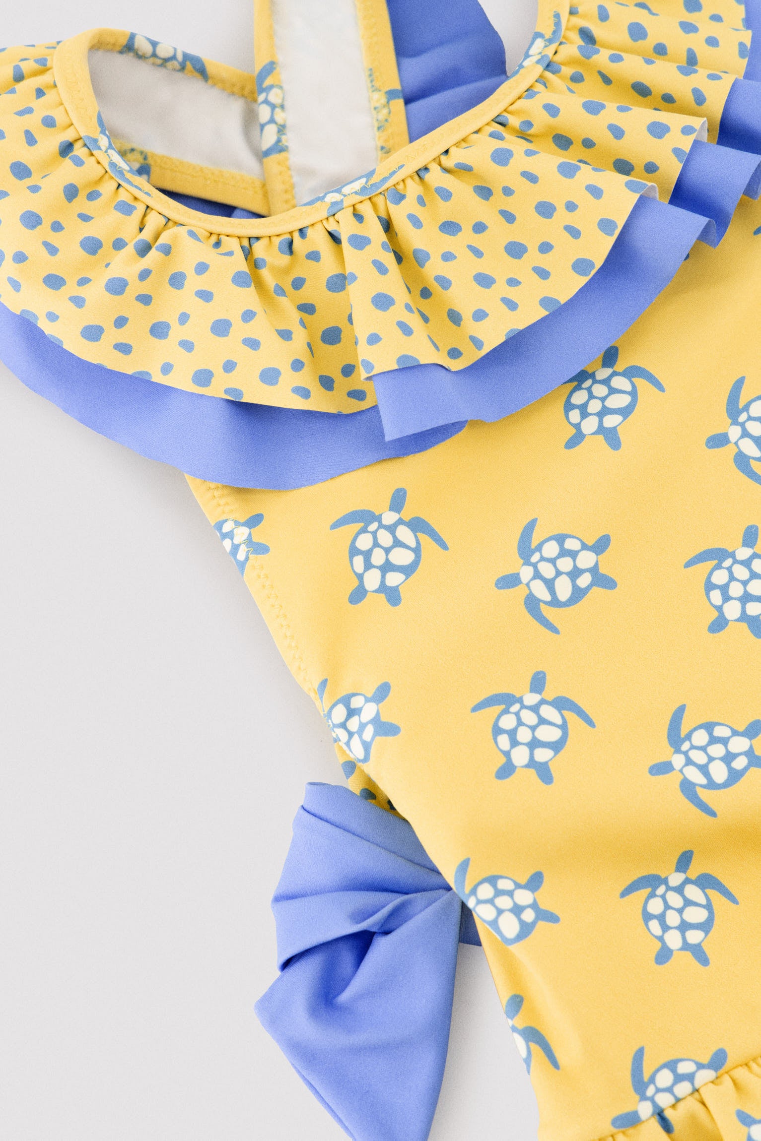 Girls' swimsuit with ruffle details and bows, turtle print