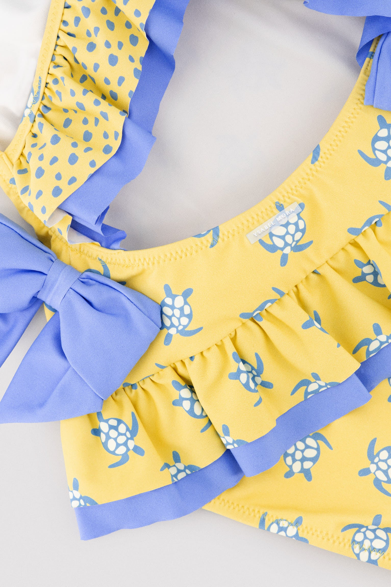 Girls' swimsuit with ruffle details and bows, turtle print