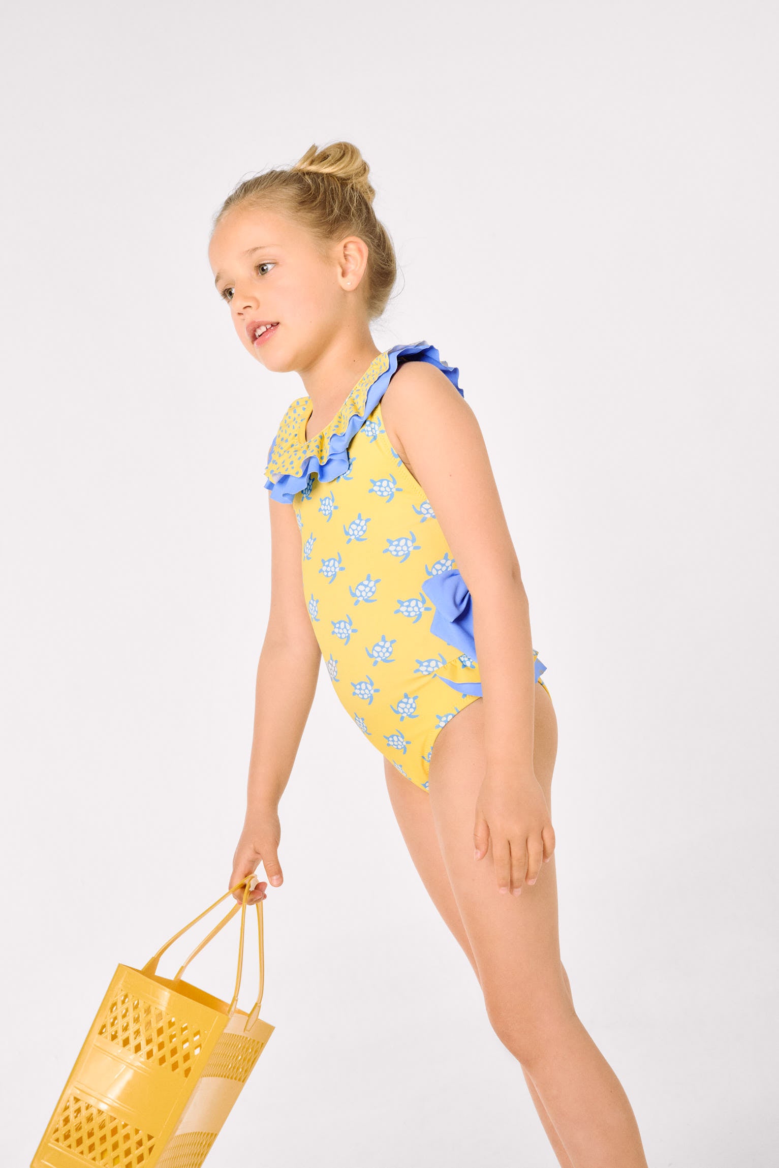 Girls' swimsuit with ruffle details and bows, turtle print