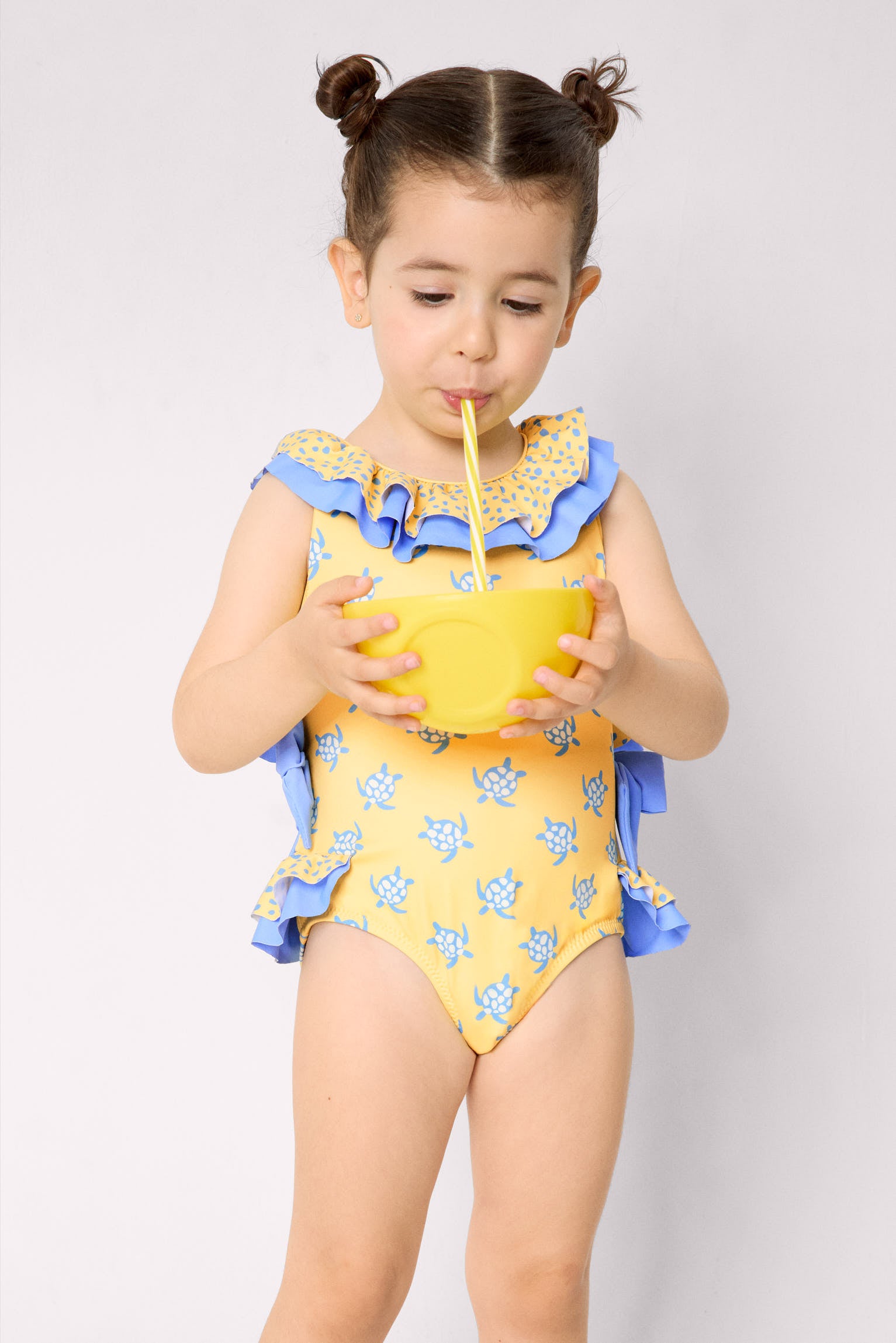 Girls' swimsuit with ruffle details and bows, turtle print