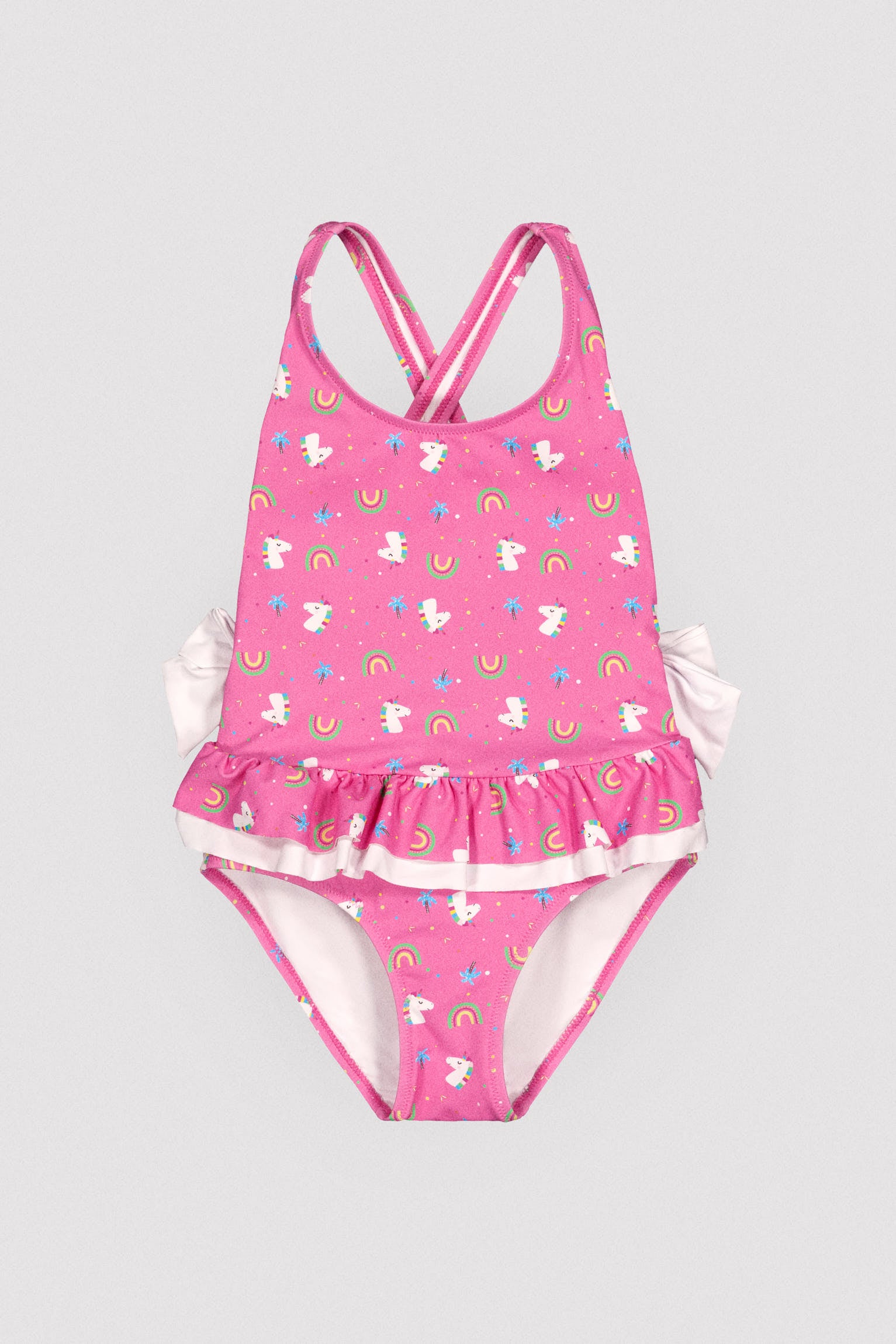 Girls' swimsuit with ruffle details and bows, unicorn print