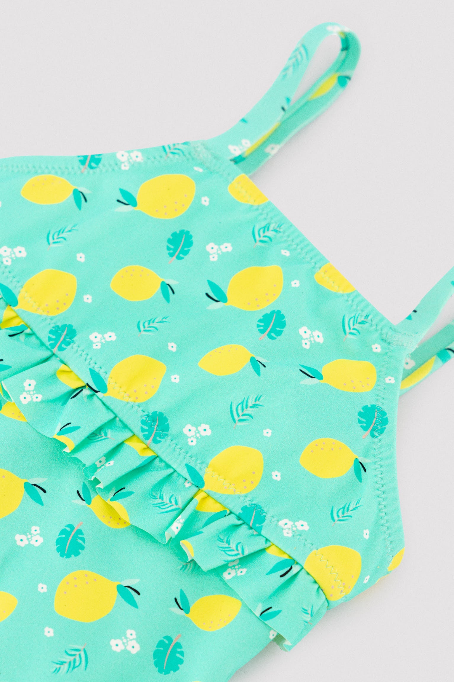 Girl's swimsuit with lemon print ruffle detail