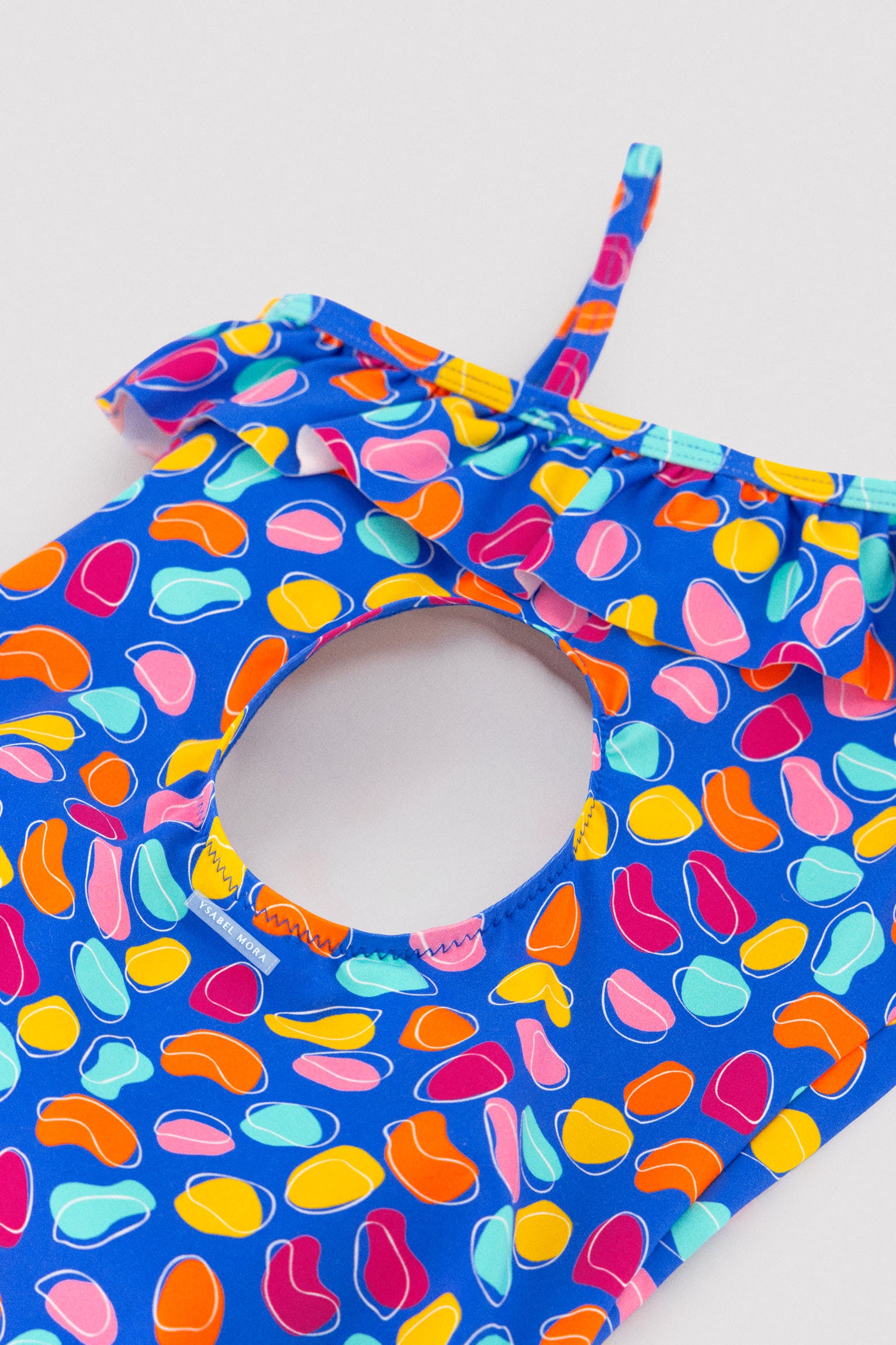 Asymmetrical swimsuit for girls with ruffle detail and organic-shaped print cut-out