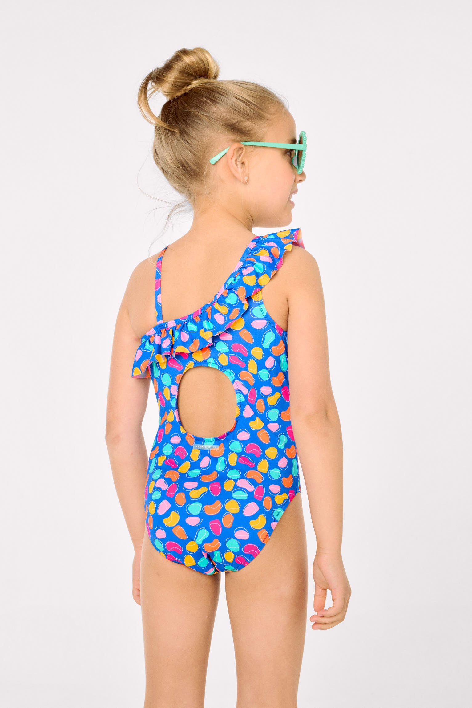Asymmetrical swimsuit for girls with ruffle detail and organic-shaped print cut-out