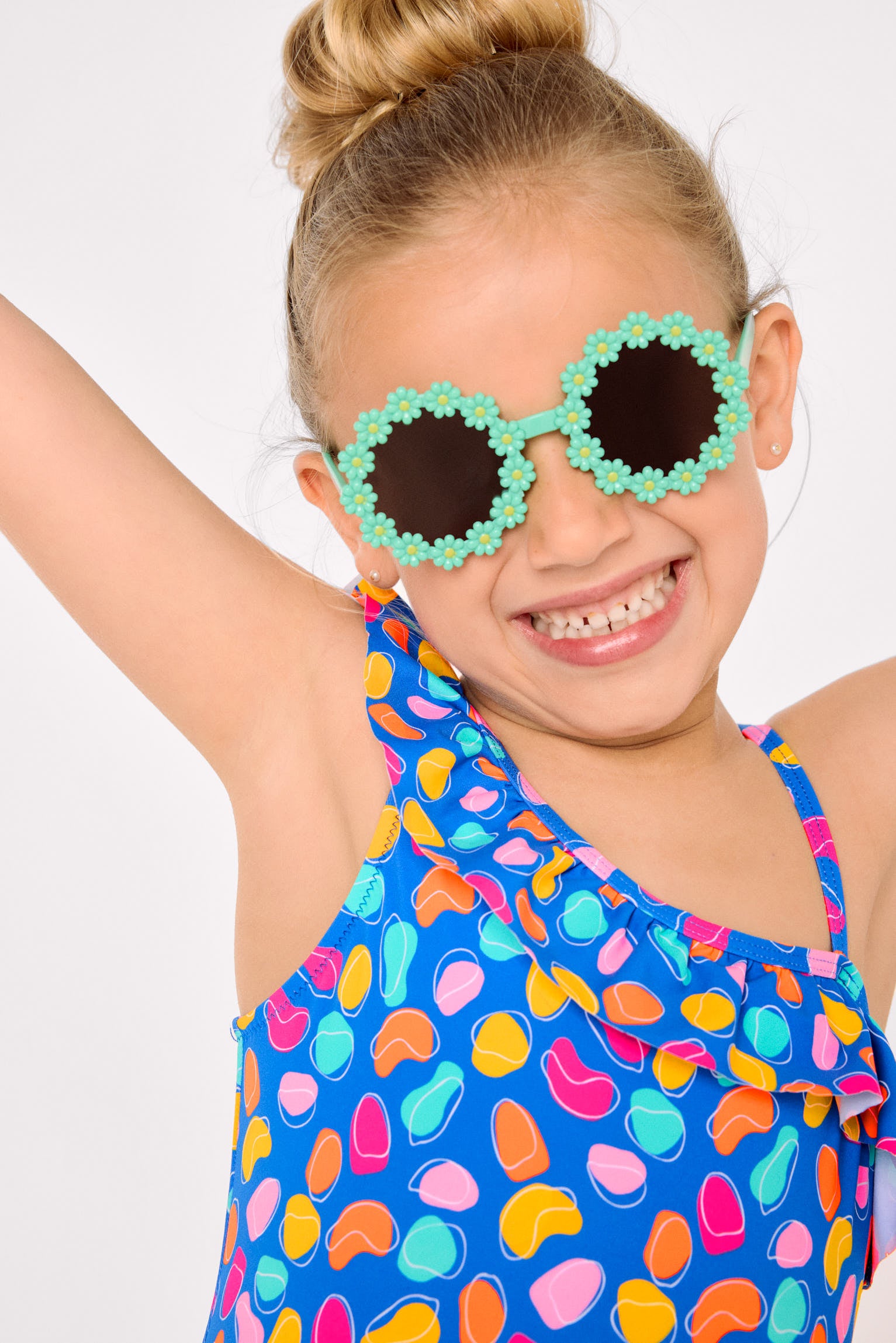 Asymmetrical swimsuit for girls with ruffle detail and organic-shaped print cut-out