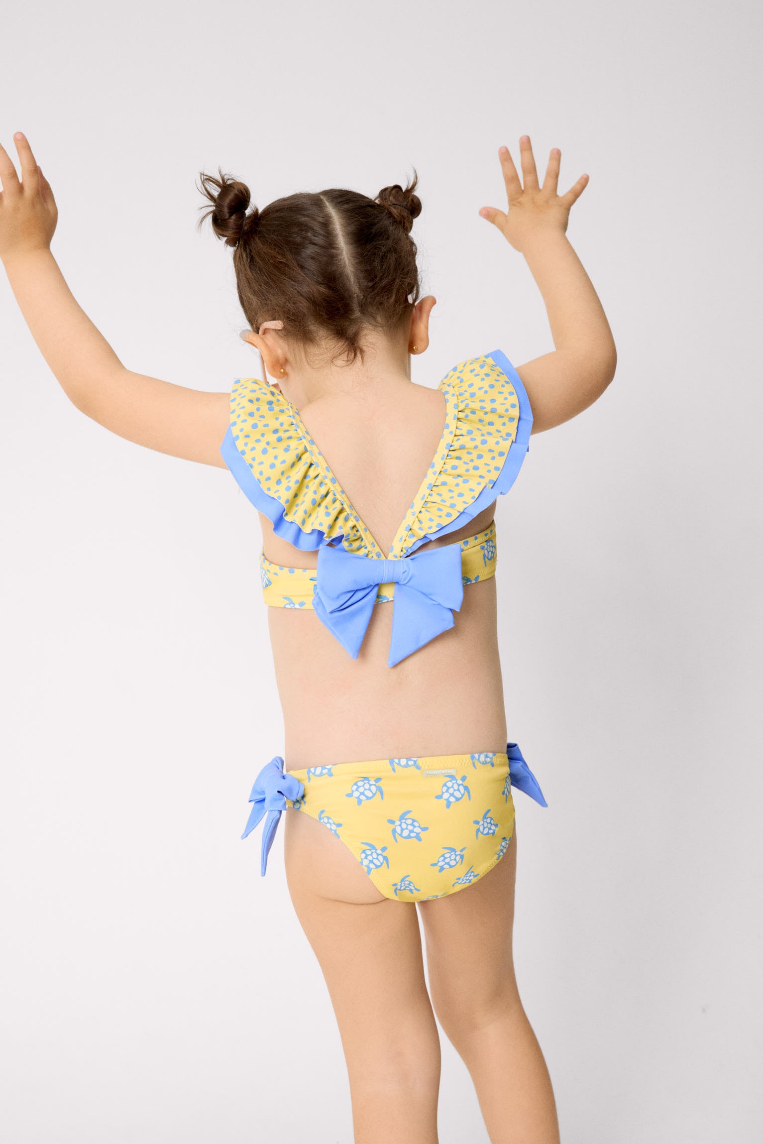 Girl's bikini with ruffle detail and bows, turtle print