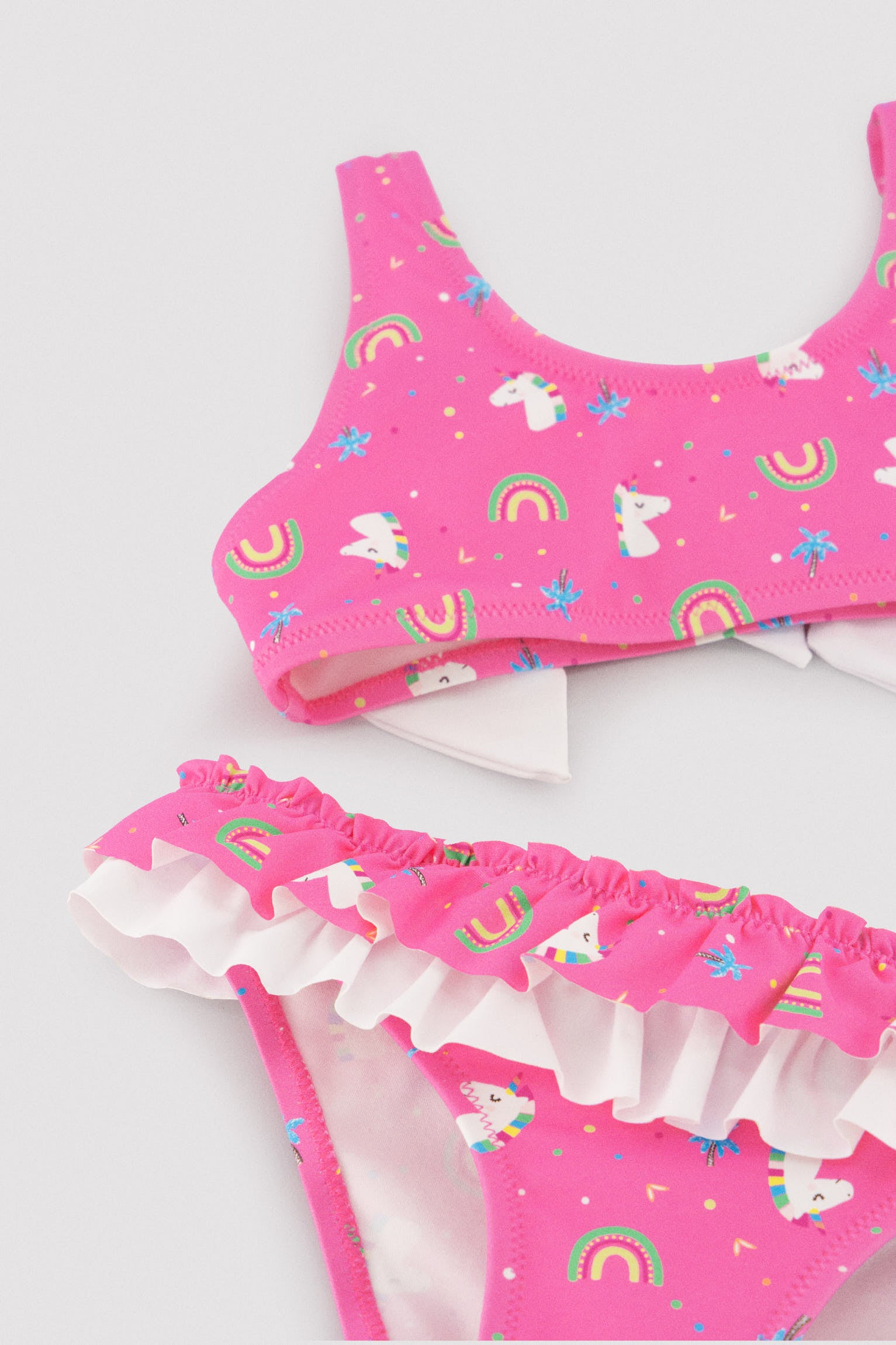 Girls' bikini with ruffle and bow details, unicorn print