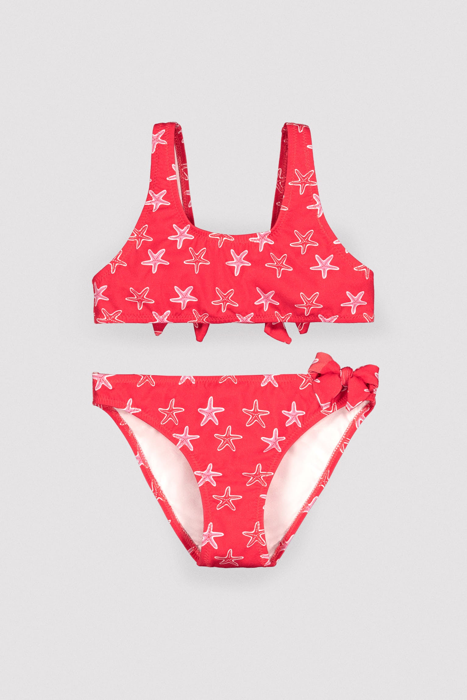 Girls' bikini with ruffle details and bows, starfish print