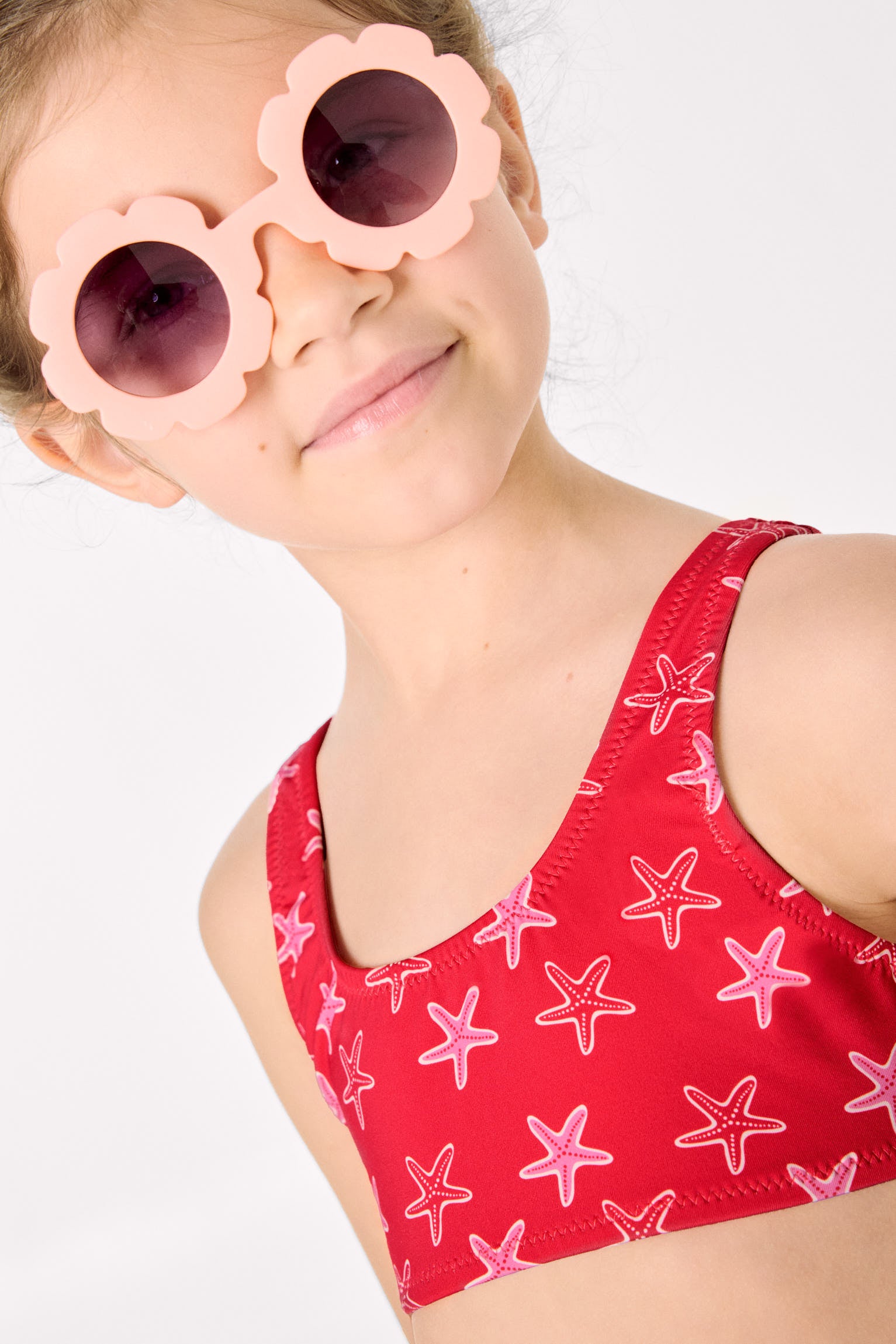 Girls' bikini with ruffle details and bows, starfish print