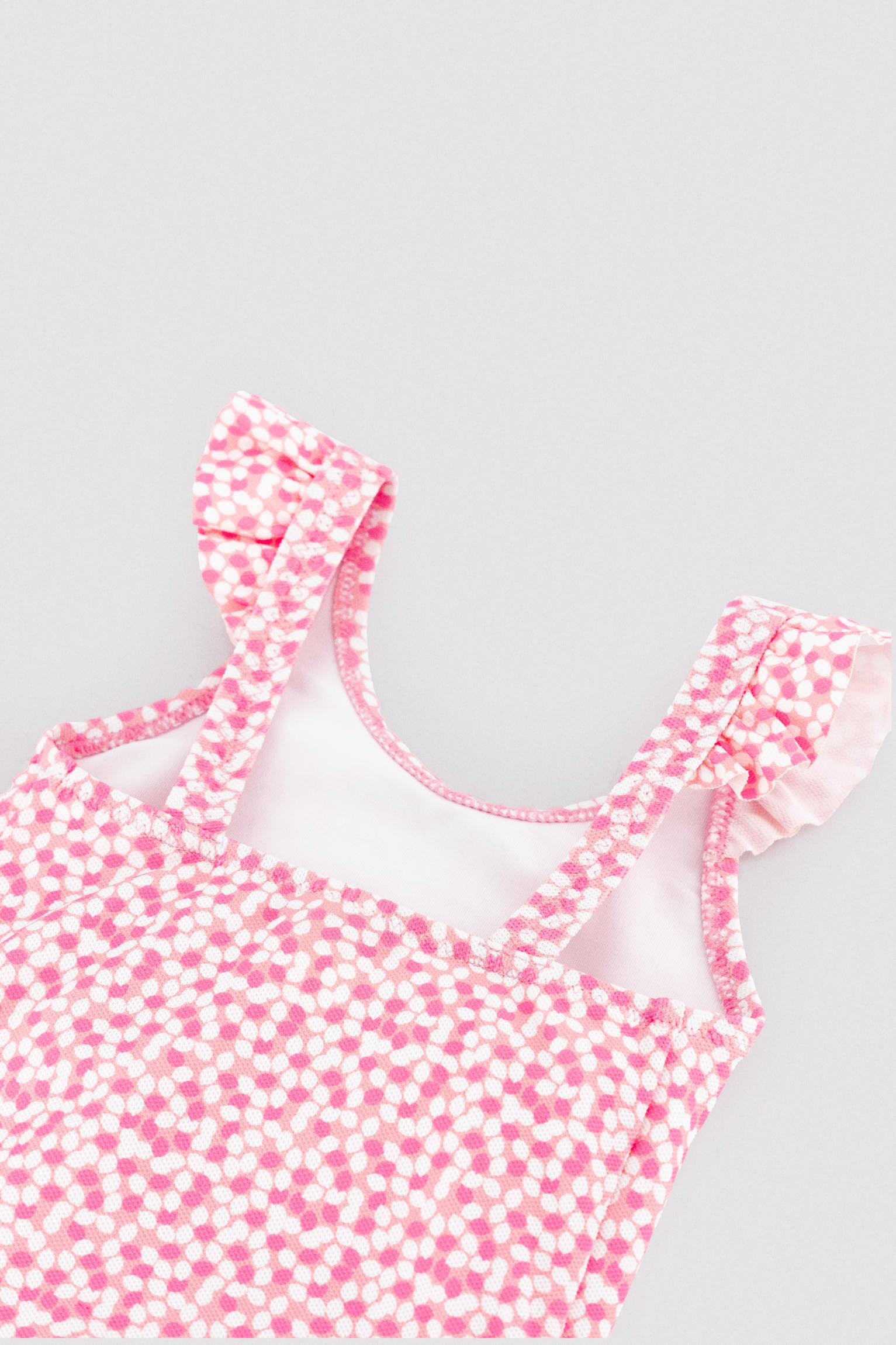 Baby girl swimsuit with ruffle details and floral print