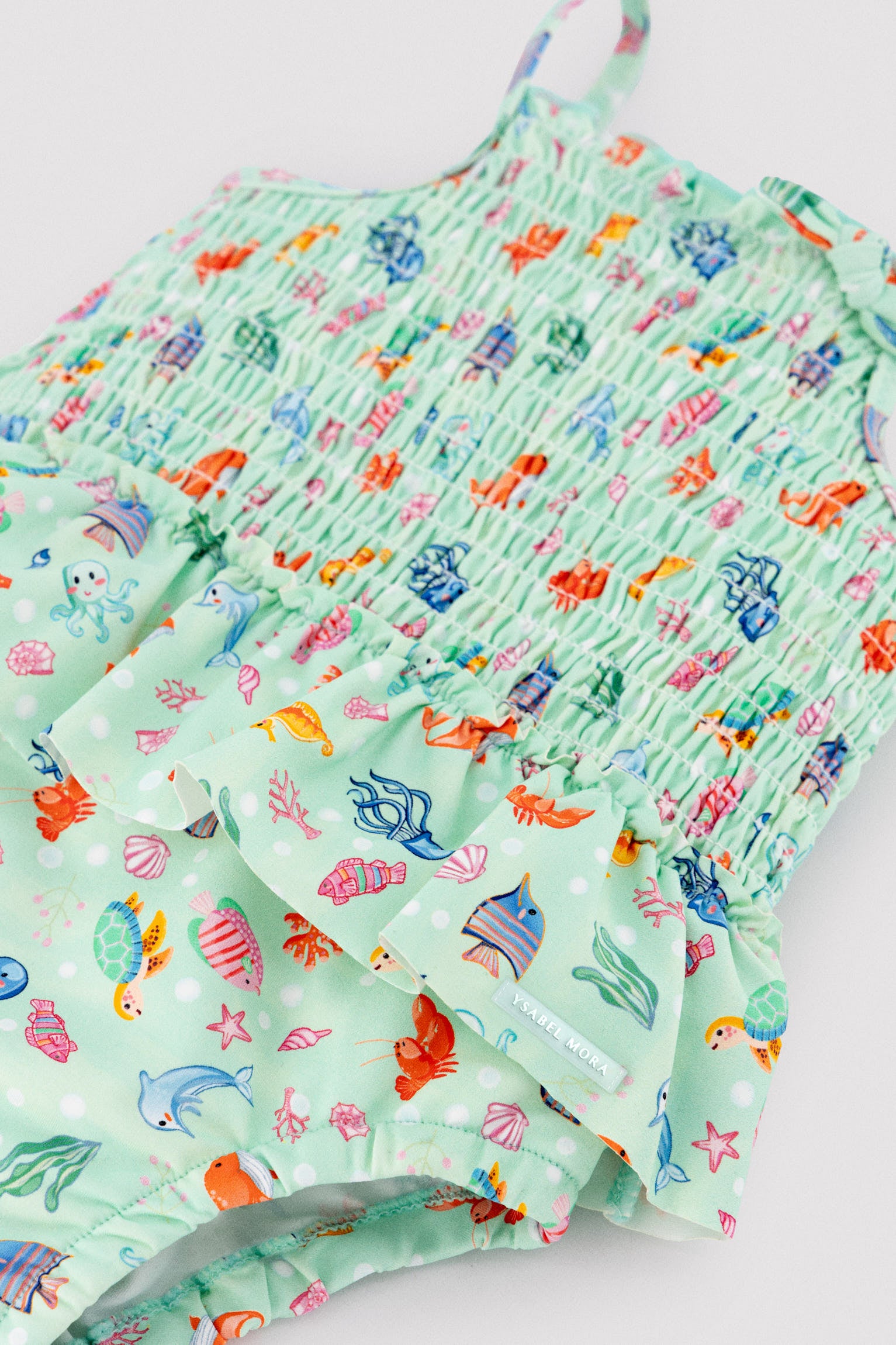 Baby girl swimsuit with ruffle detail and honeycomb print with marine fauna pattern