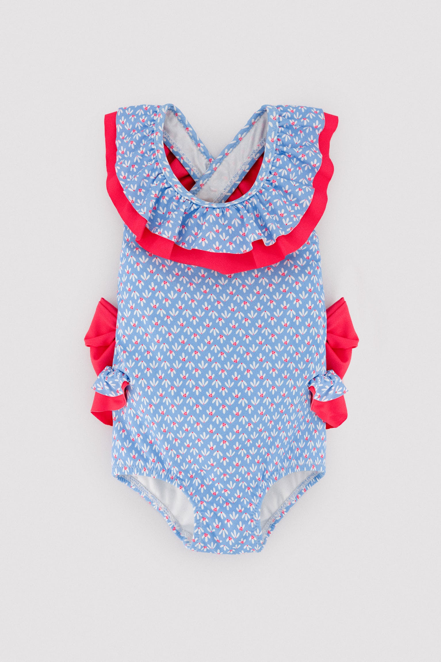 Baby girl swimsuit with ruffle and bow details, floral print