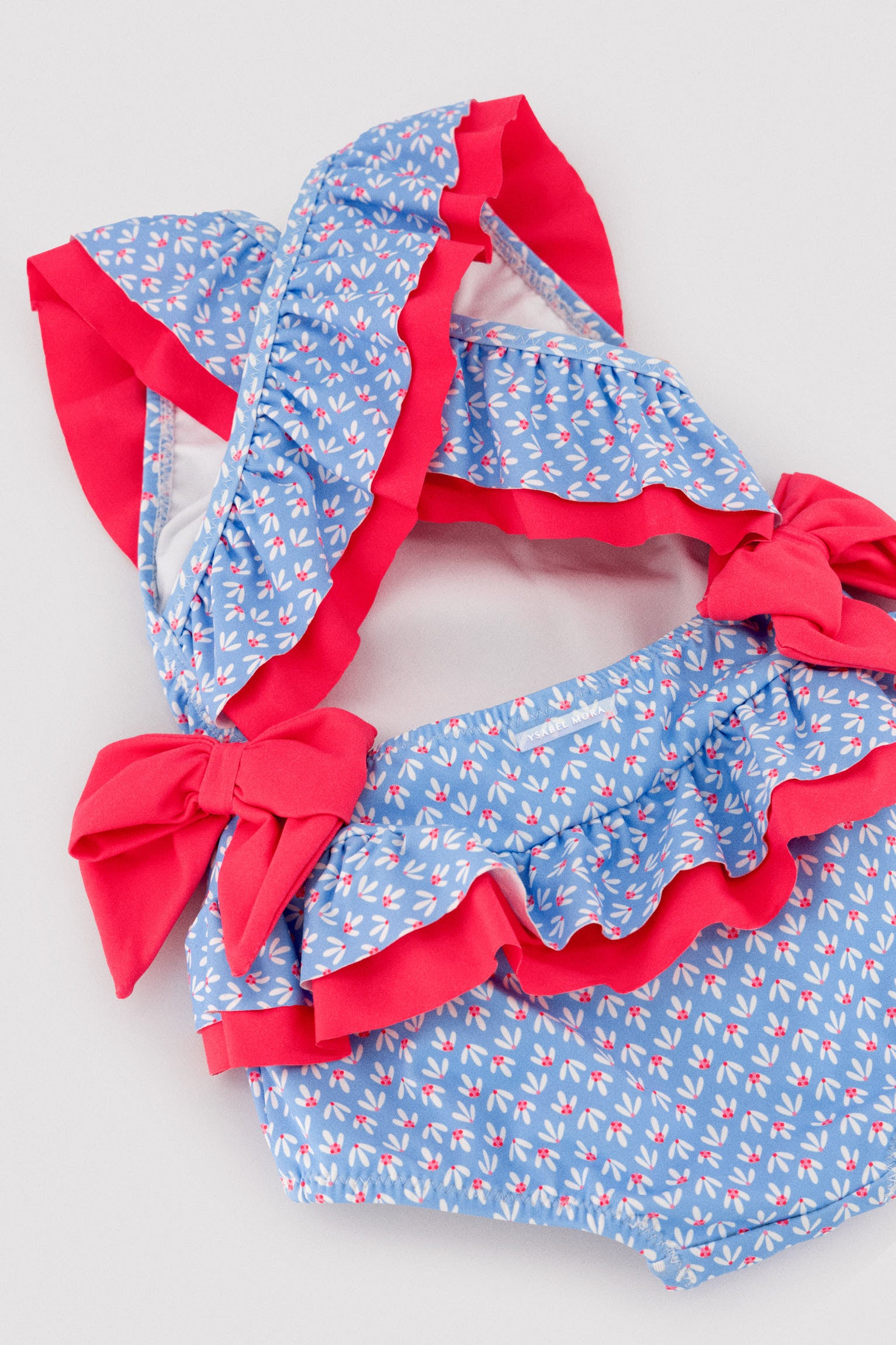 Baby girl swimsuit with ruffle and bow details, floral print