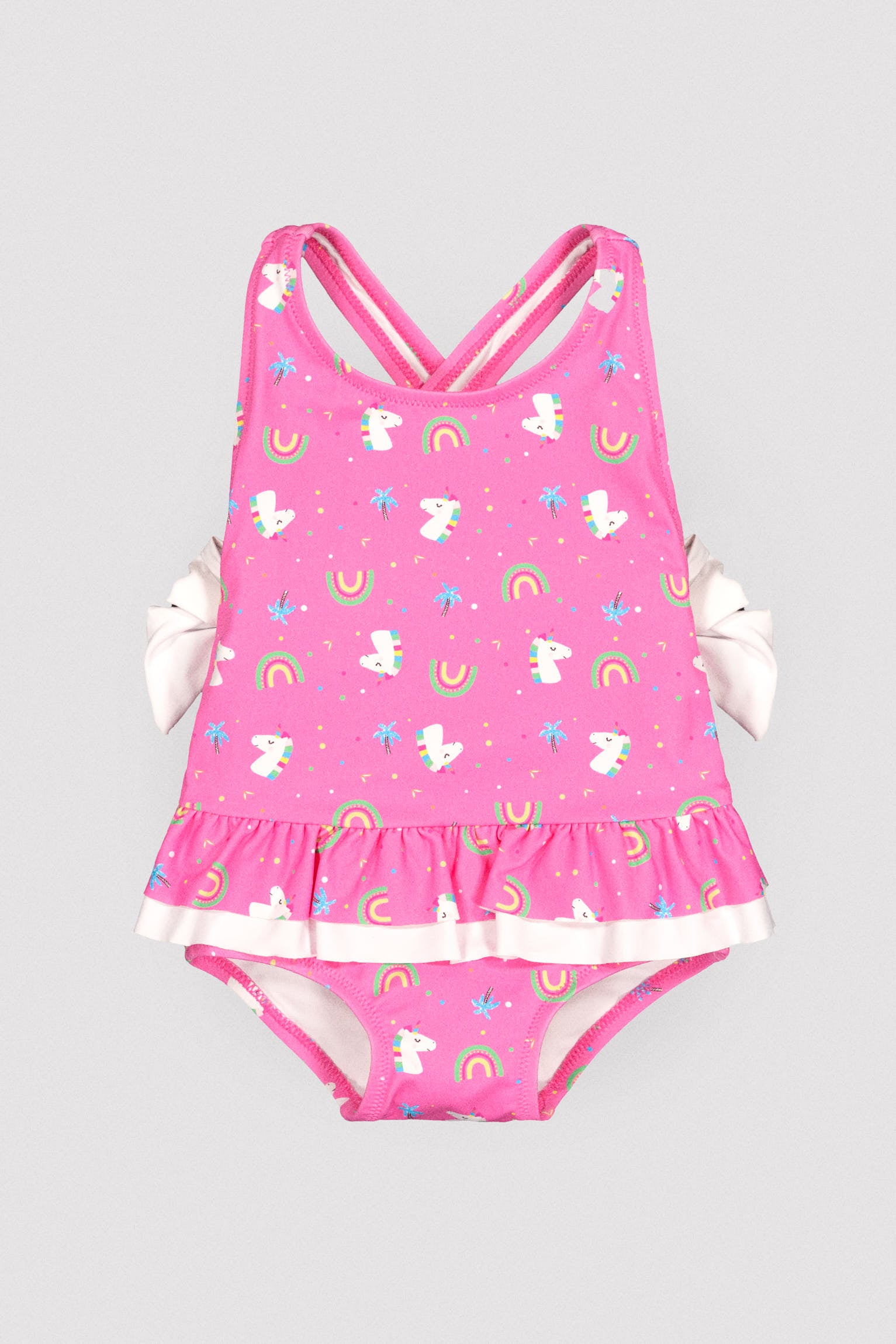 Baby girl swimsuit with ruffle and bow details, unicorn print