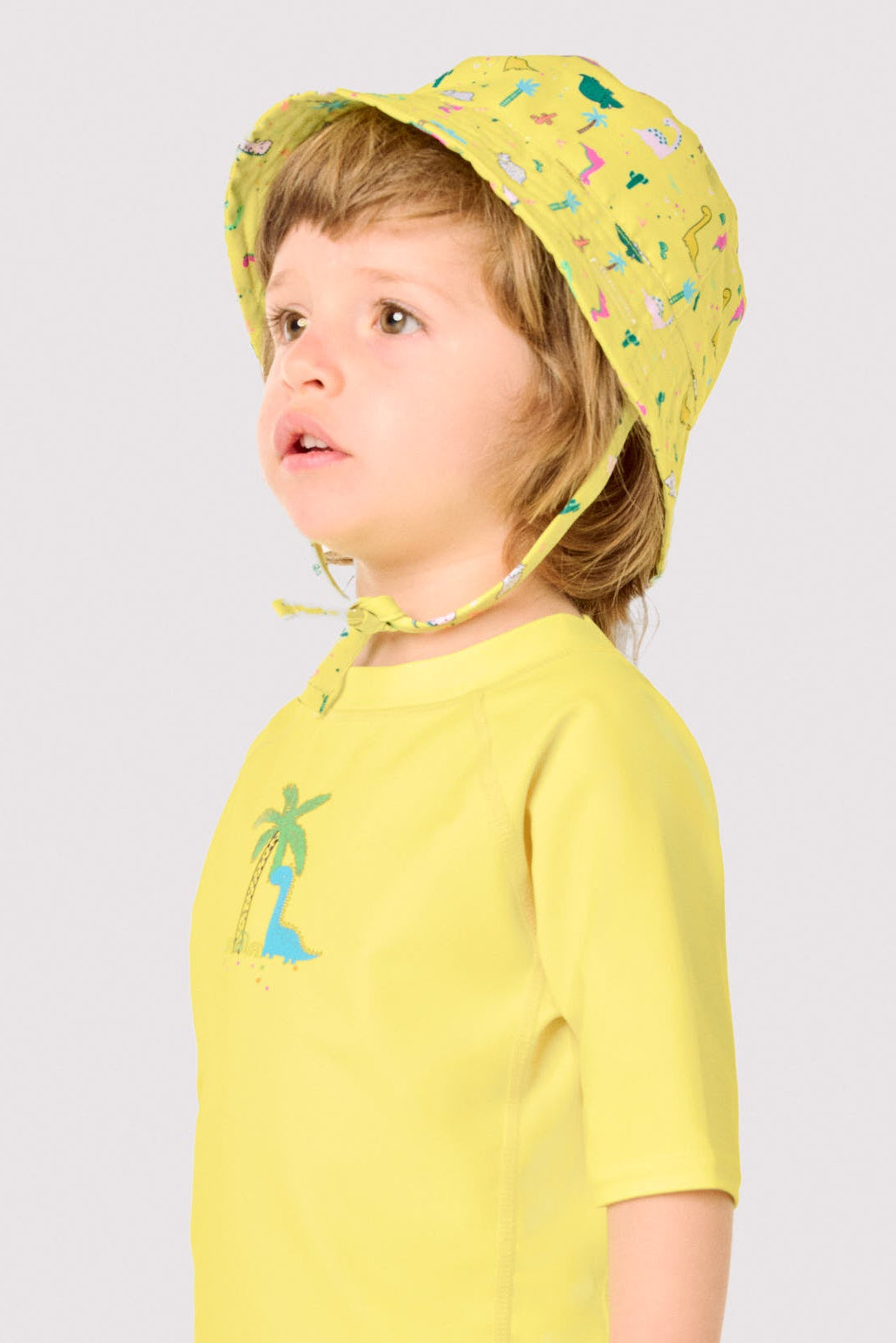 Baby beach hat with straight brim and dinosaur print