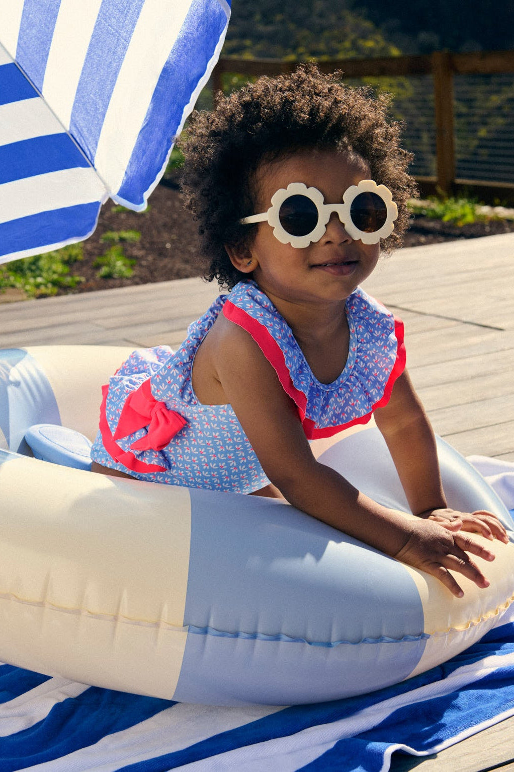 Baby girl swimsuit with ruffle and bow details, floral print