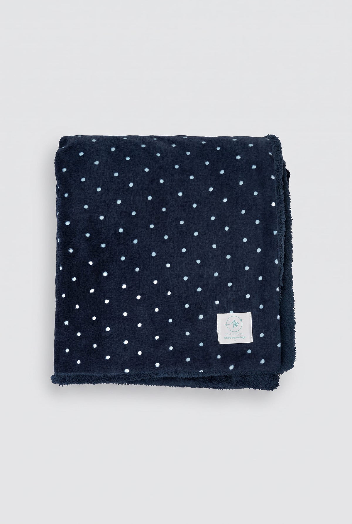 Navy polka-dot coral fleece and shearling blanket