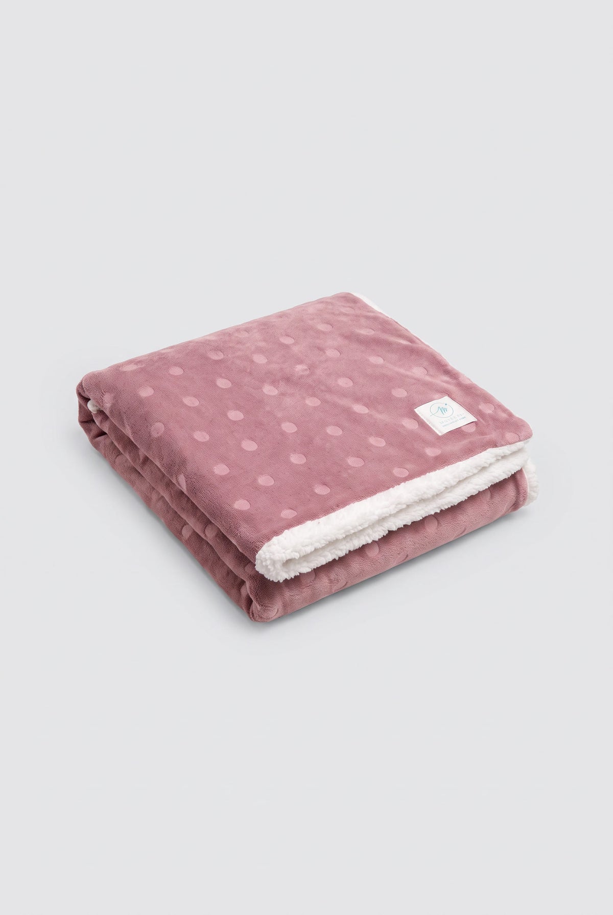 Polka-dot coral fleece and shearling blanket