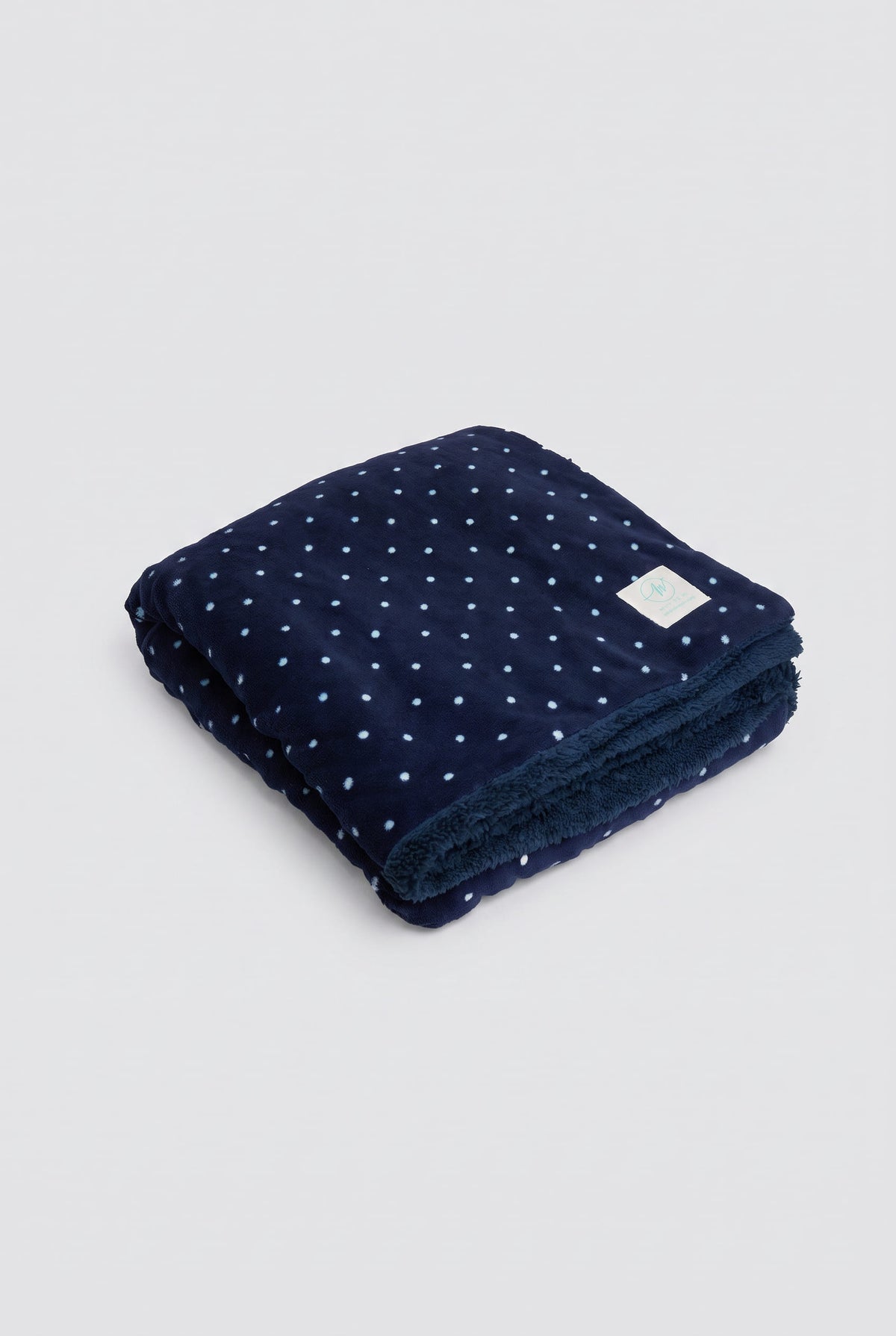 Navy polka-dot coral fleece and shearling blanket