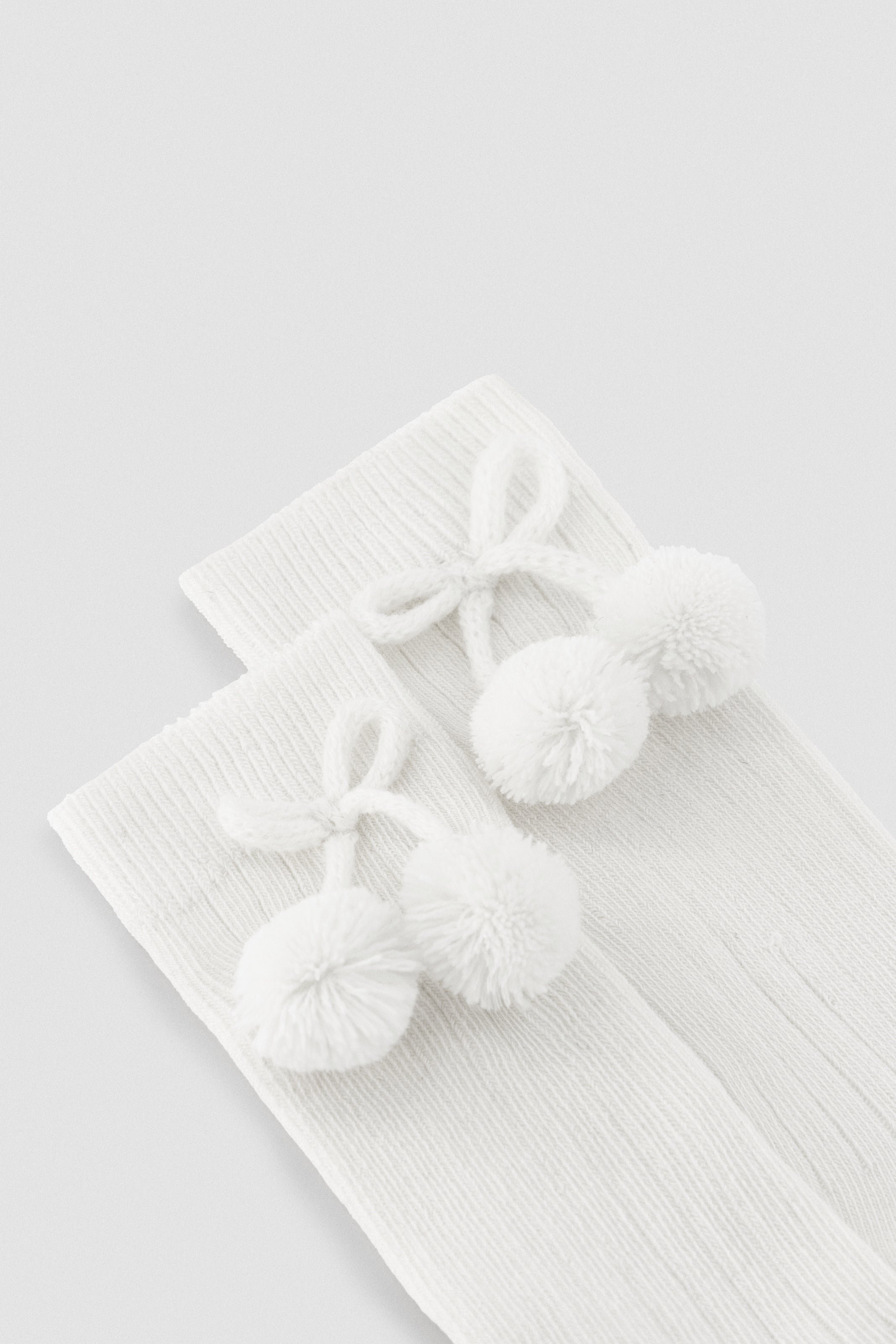 Long white pompom socks
