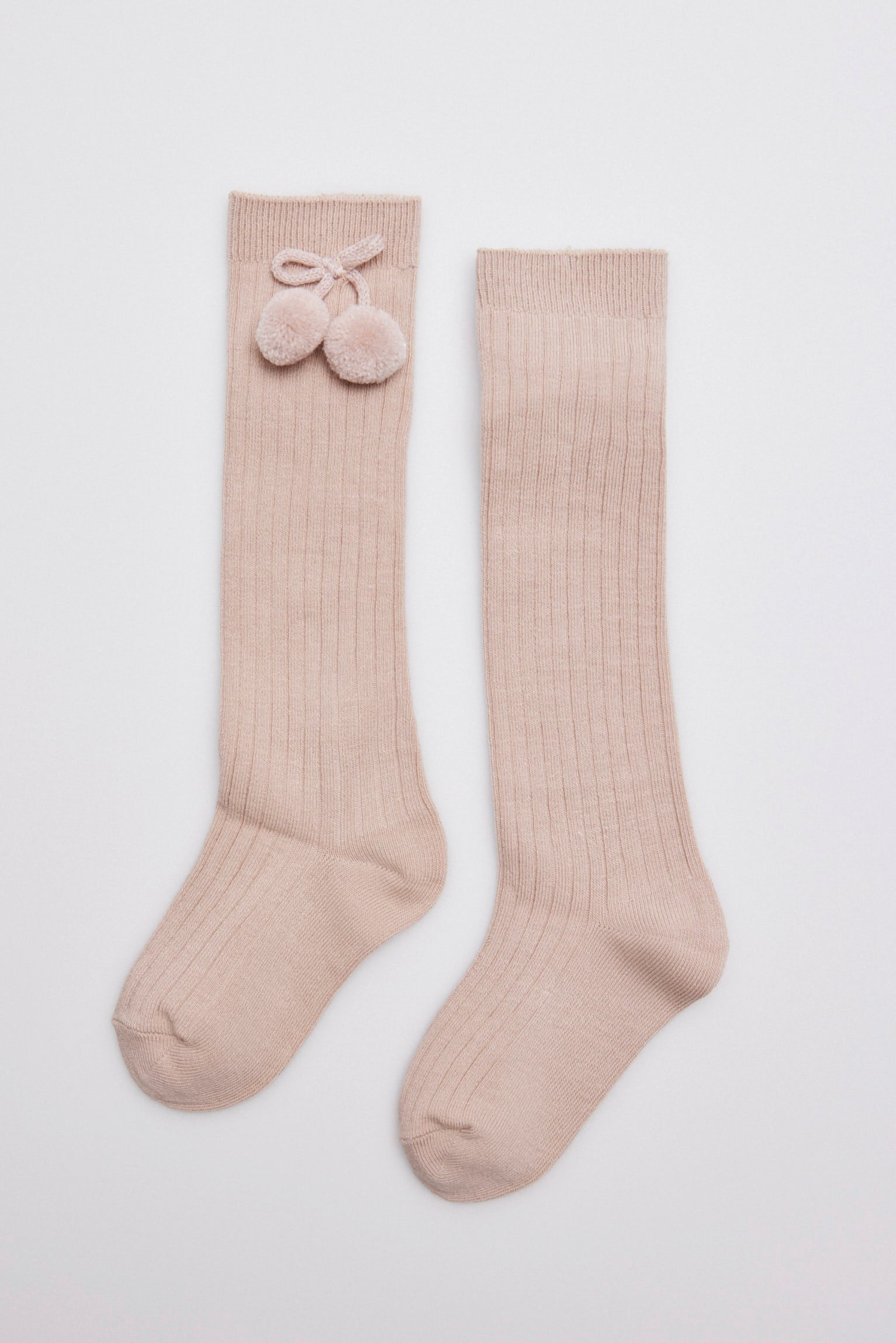 Children's long beige socks with pompom details
