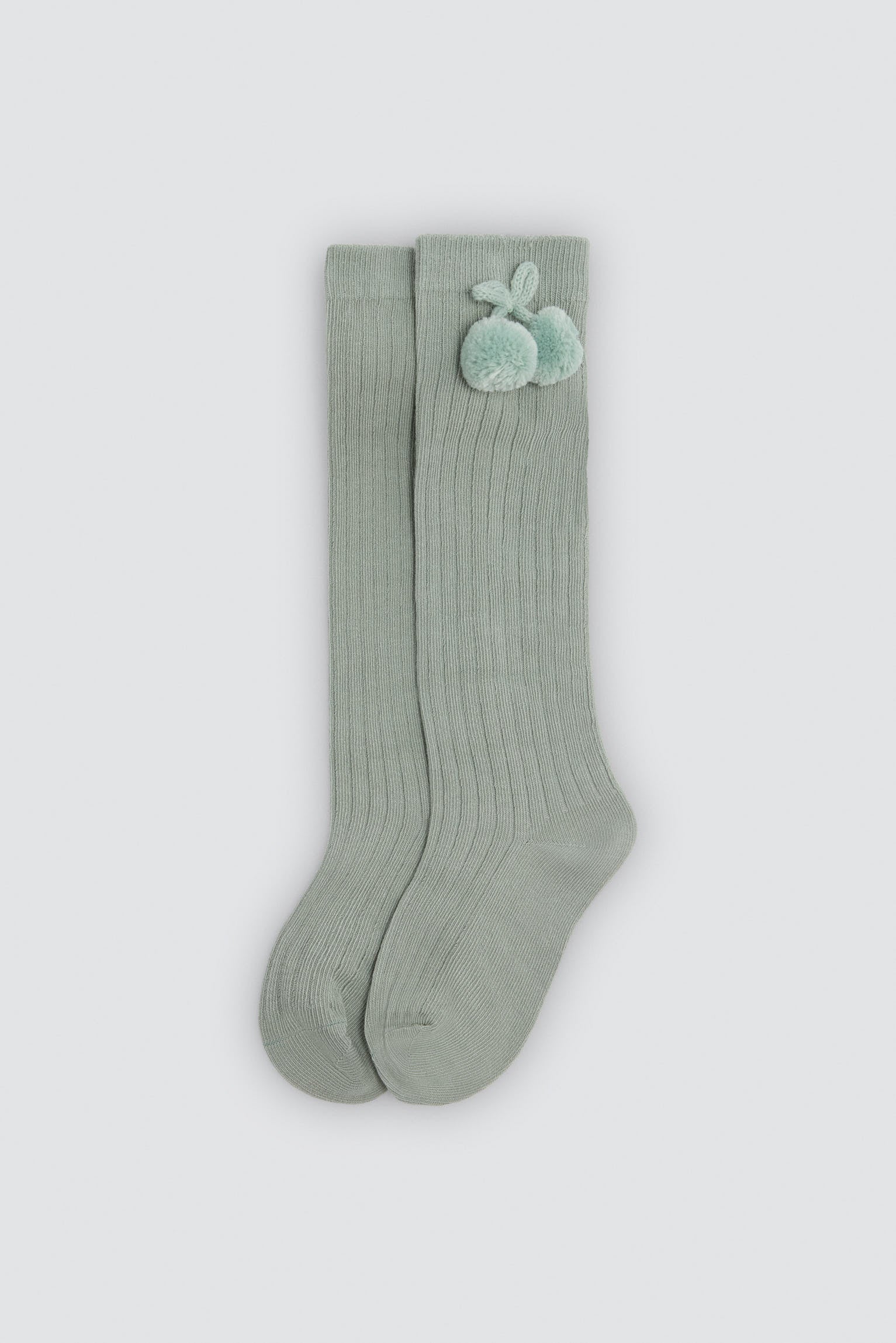 Children's long green socks with pompom details