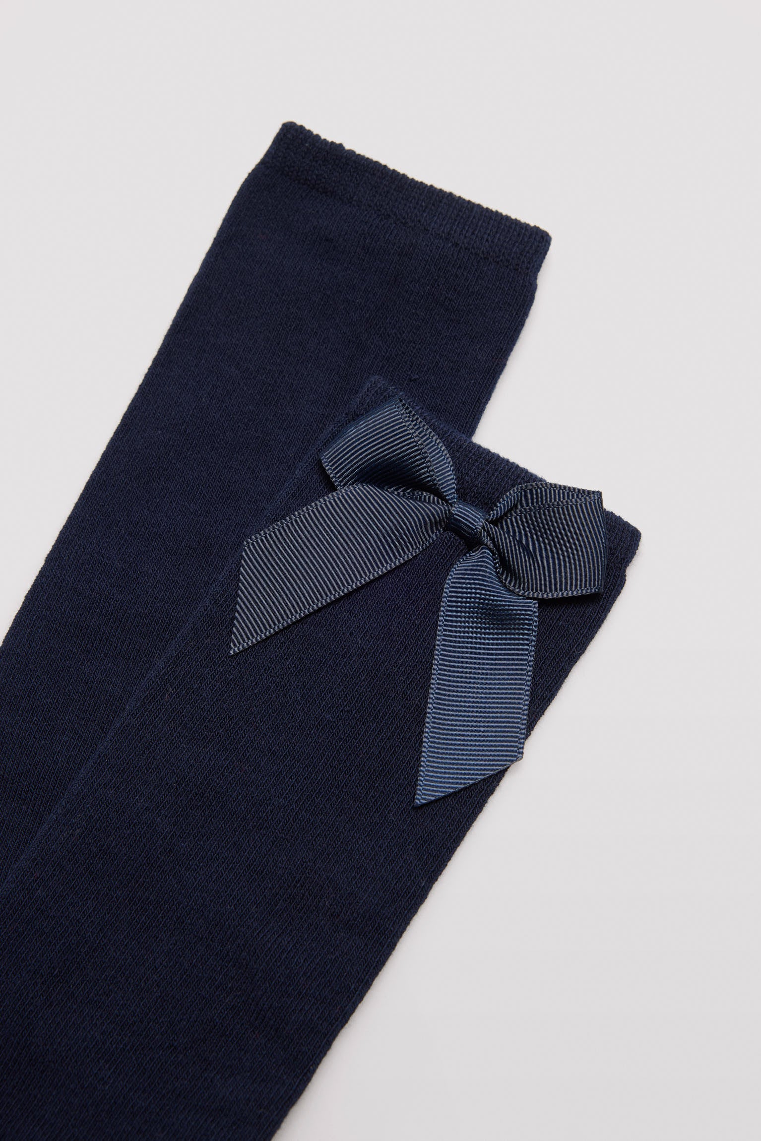 Long children's sock with navy bow detail