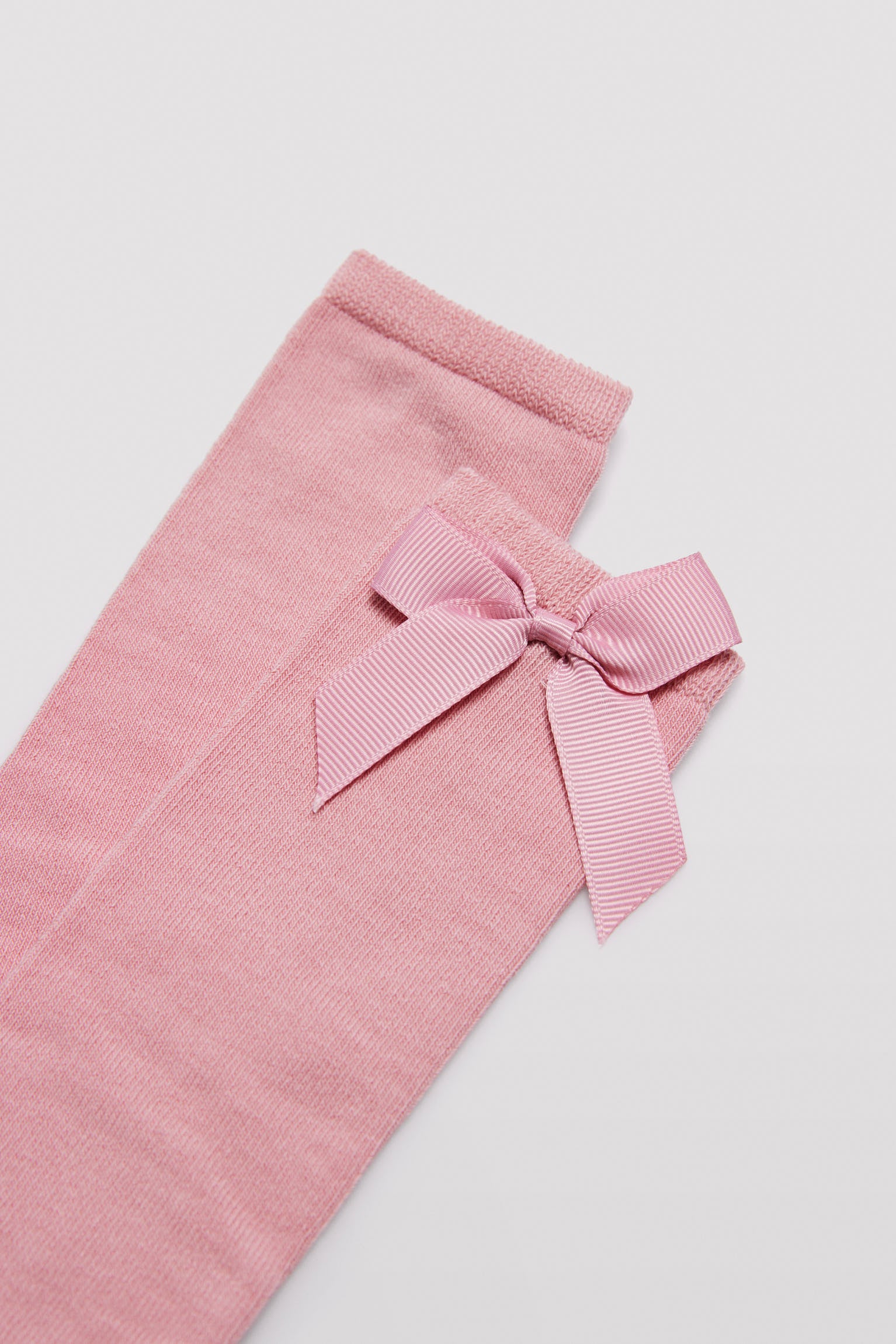 Long children's sock with pink bow detail