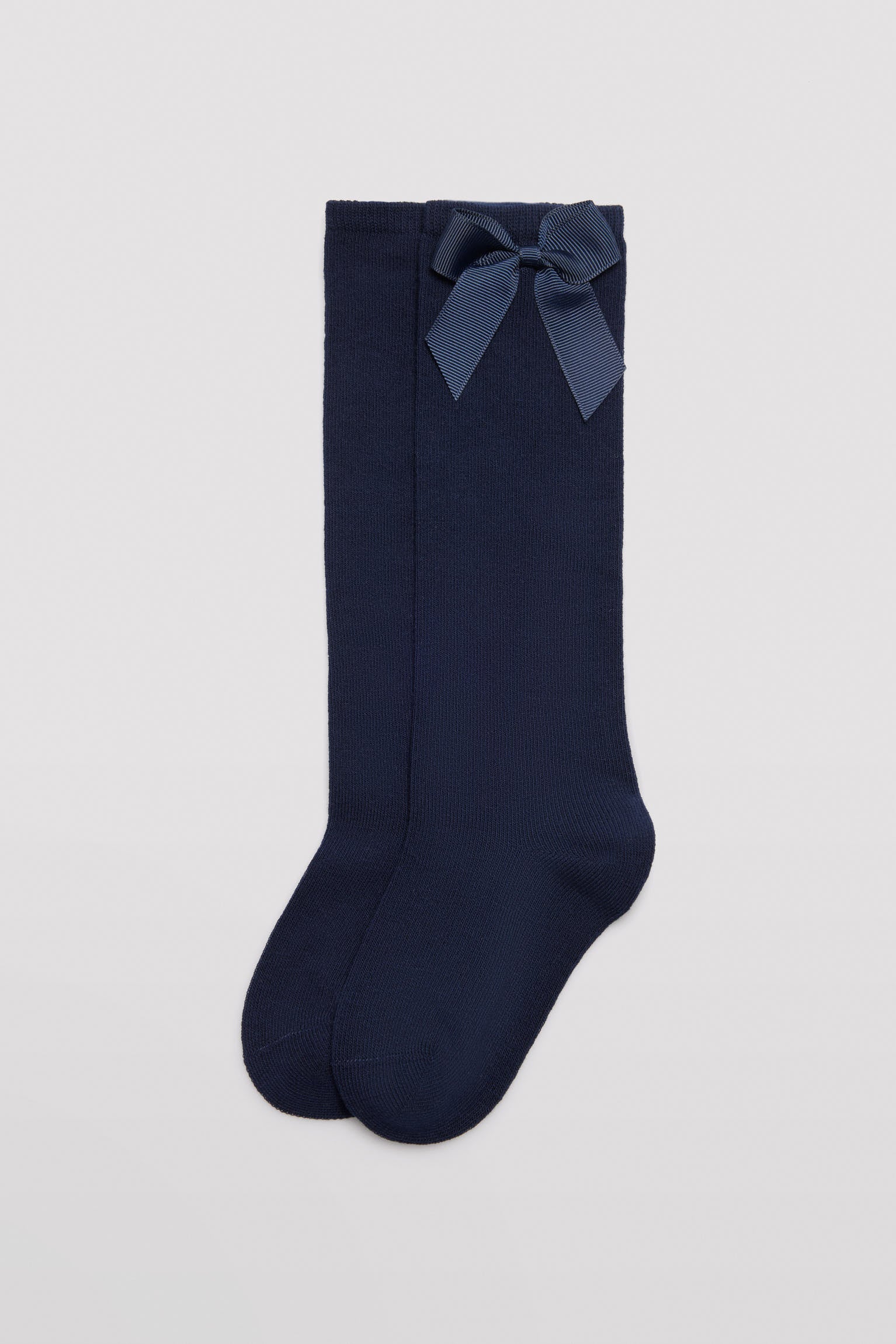 Long children's sock with navy bow detail