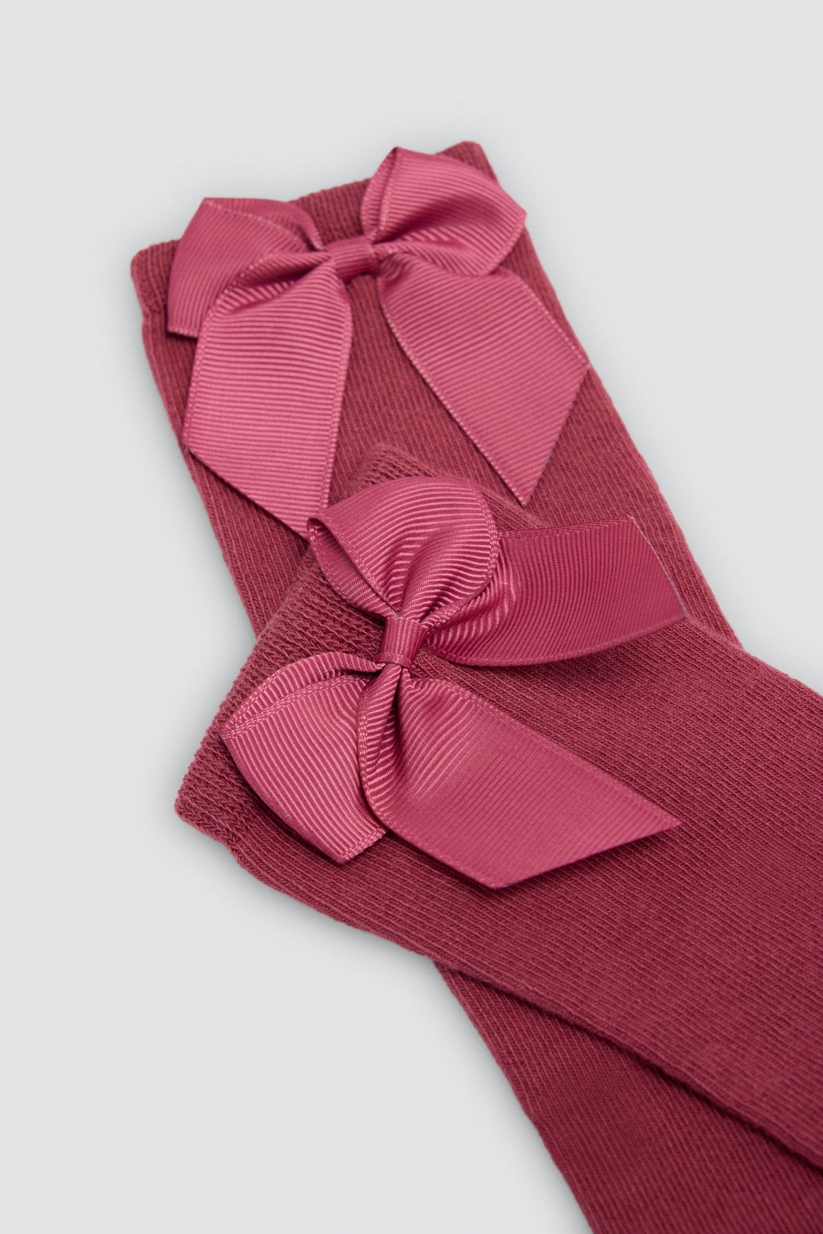Long children's sock with pink bow detail