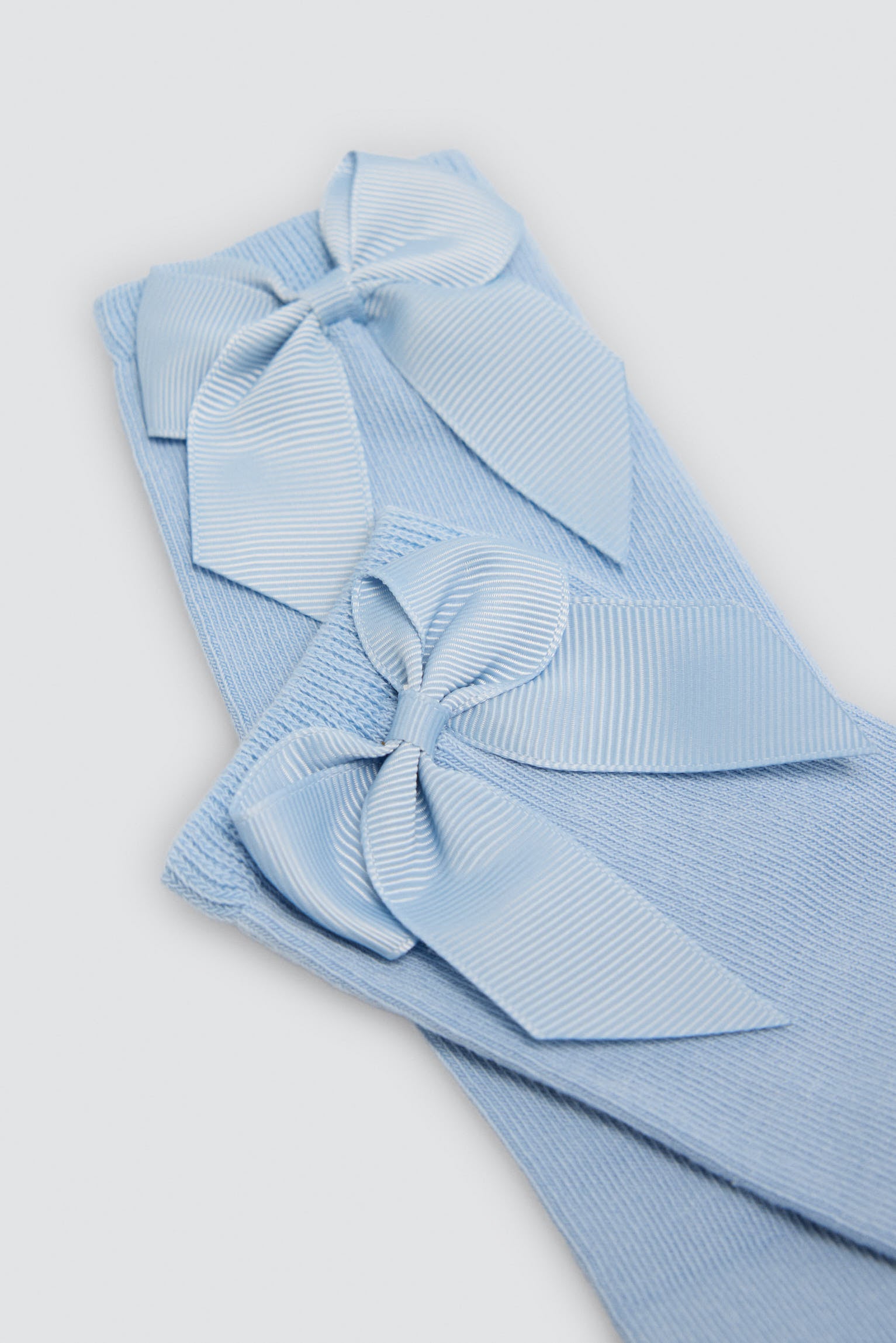 Children's long blue socks with bow detail