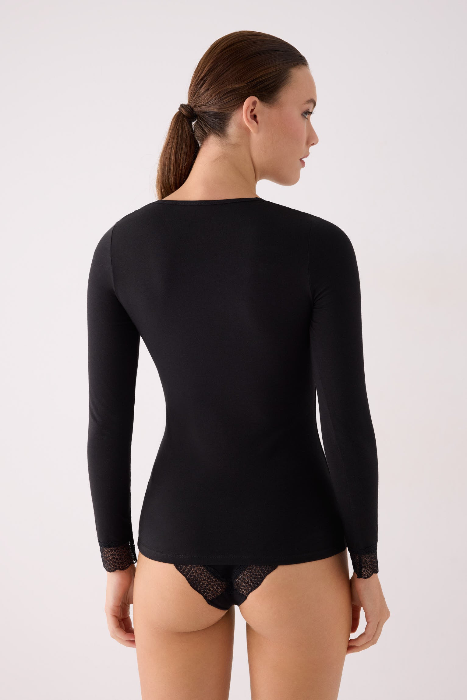 Black long-sleeve top with lace details