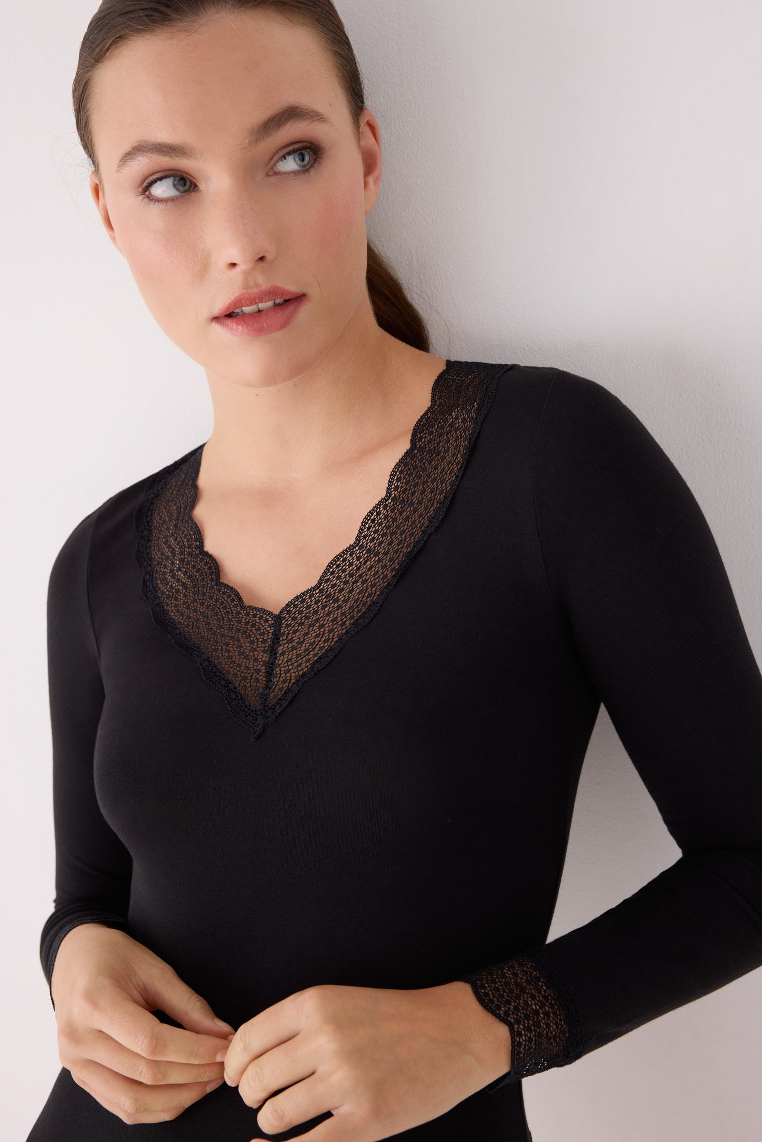 Black long-sleeve top with lace details