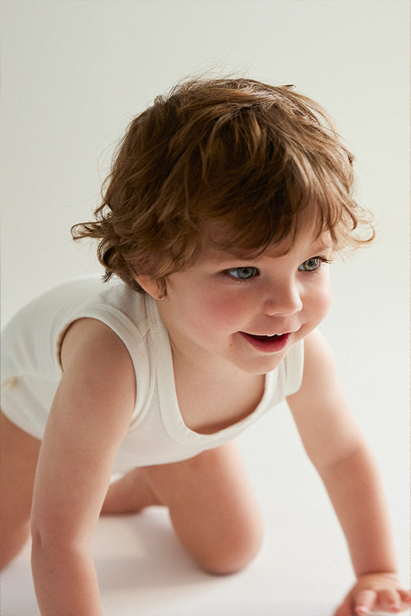 Basic baby bodysuit with wide white straps