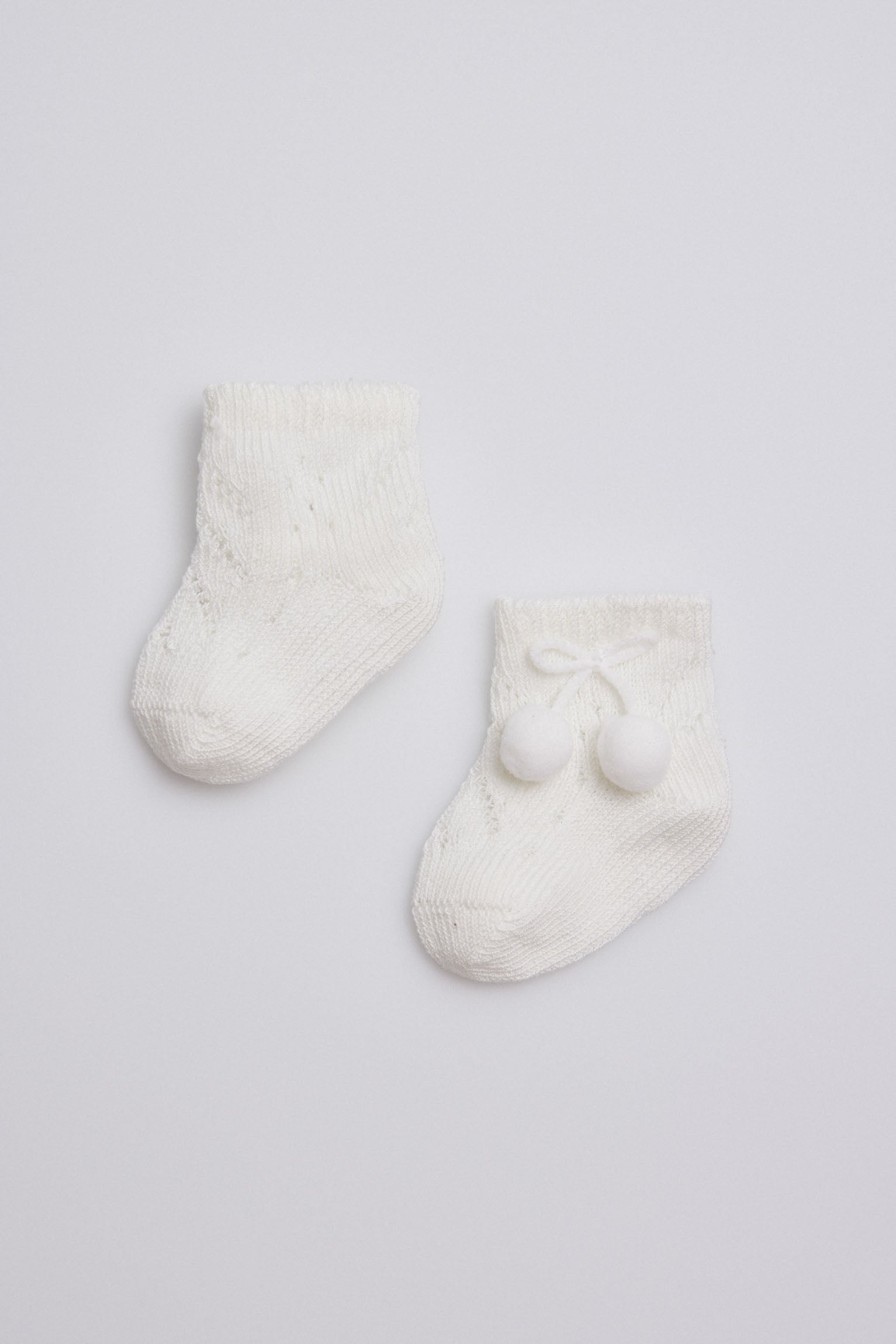 Ivory newborn pearl socks with tassels