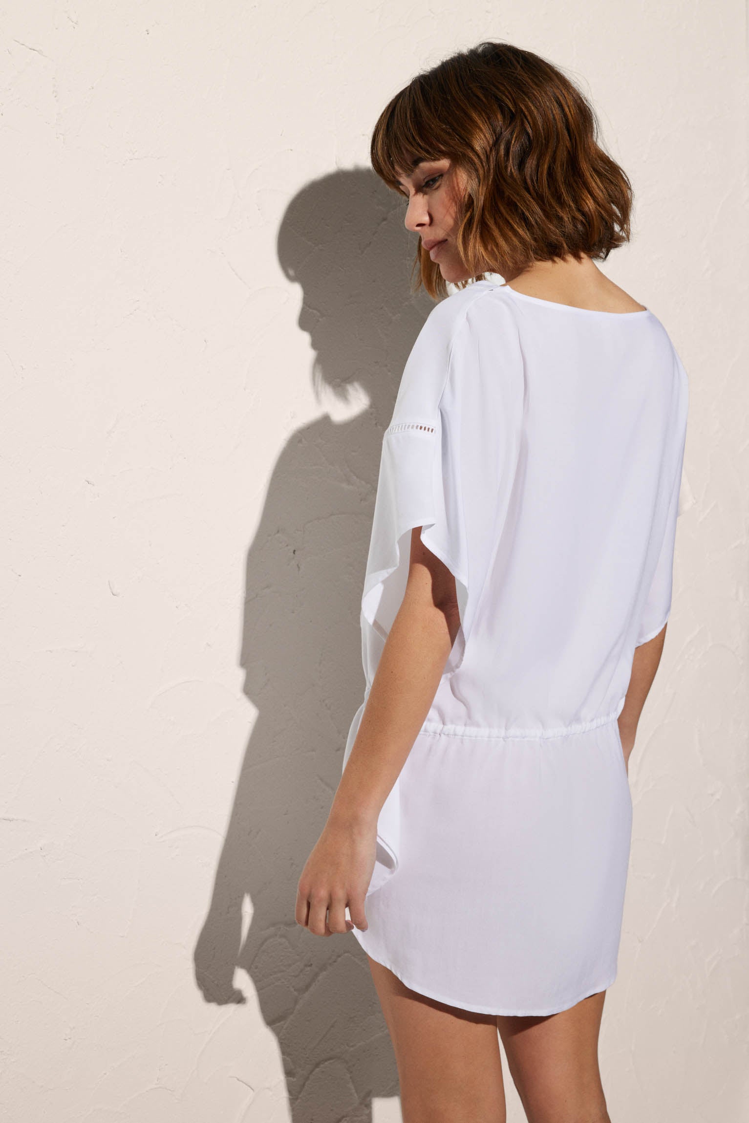 Short plain white kaftan with bow and pompom detail