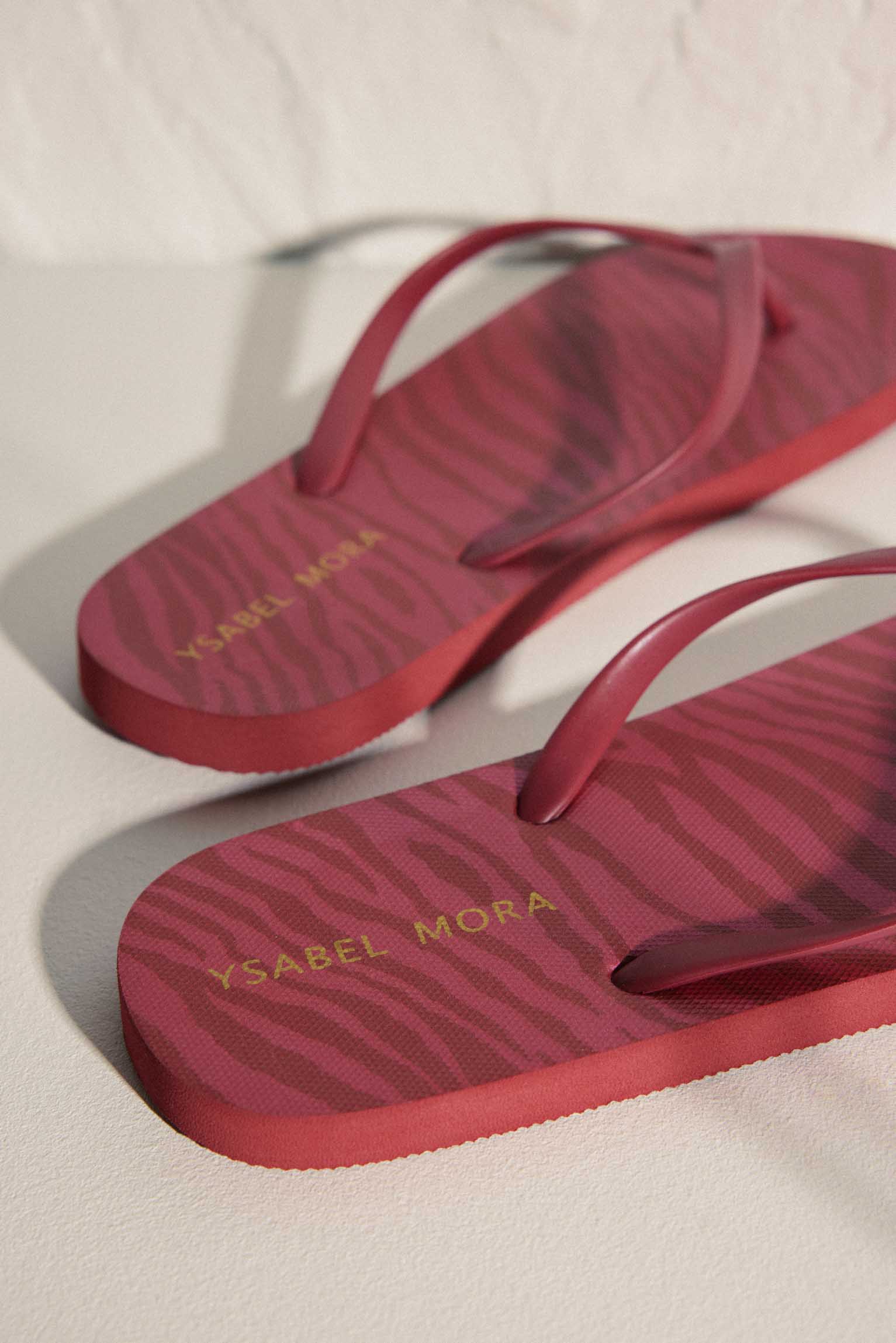 Flat beach flip flops with red animal print