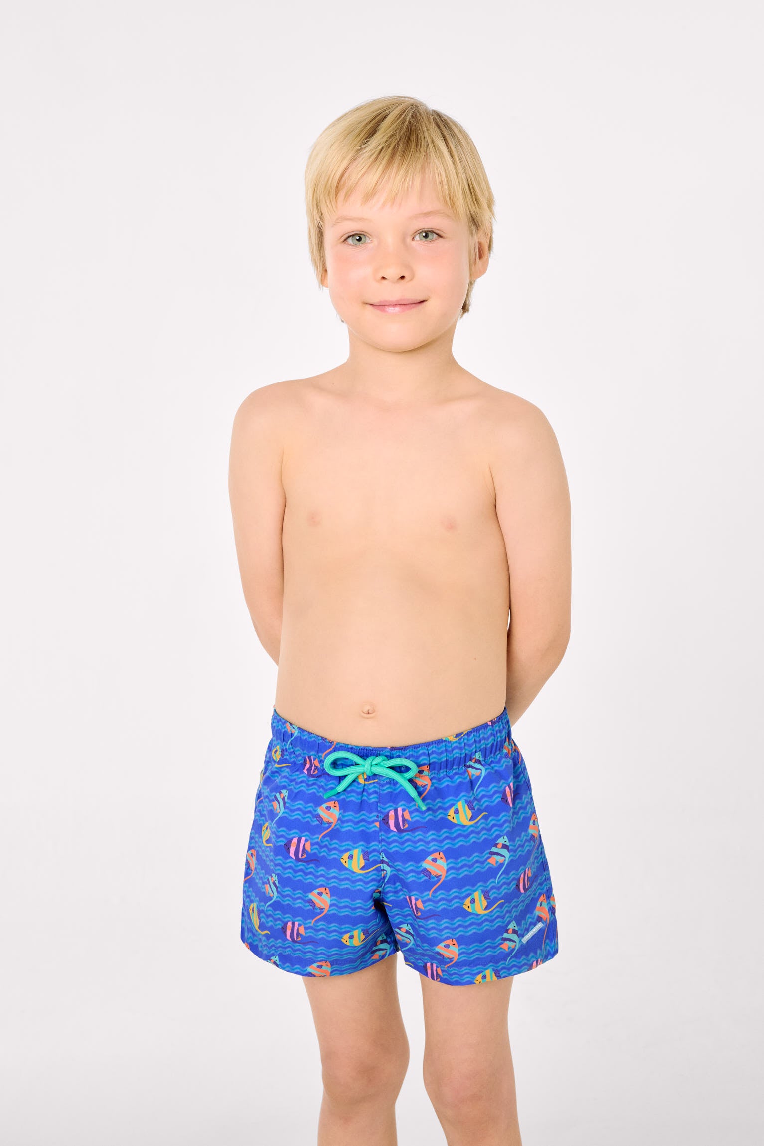 Boys' short swim trunks with a multicolored tropical fish print