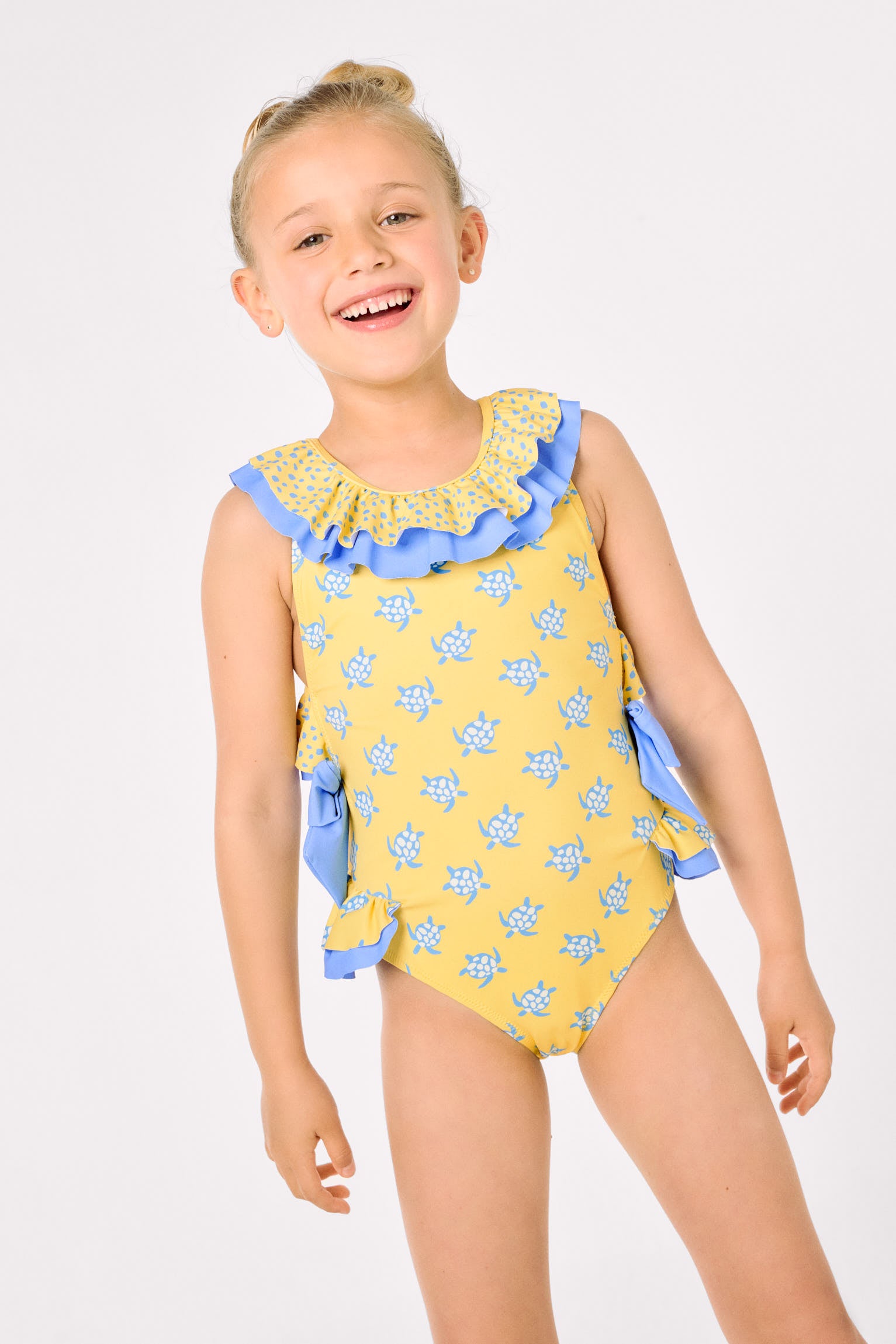 Girls' swimsuit with ruffle details and bows, turtle print
