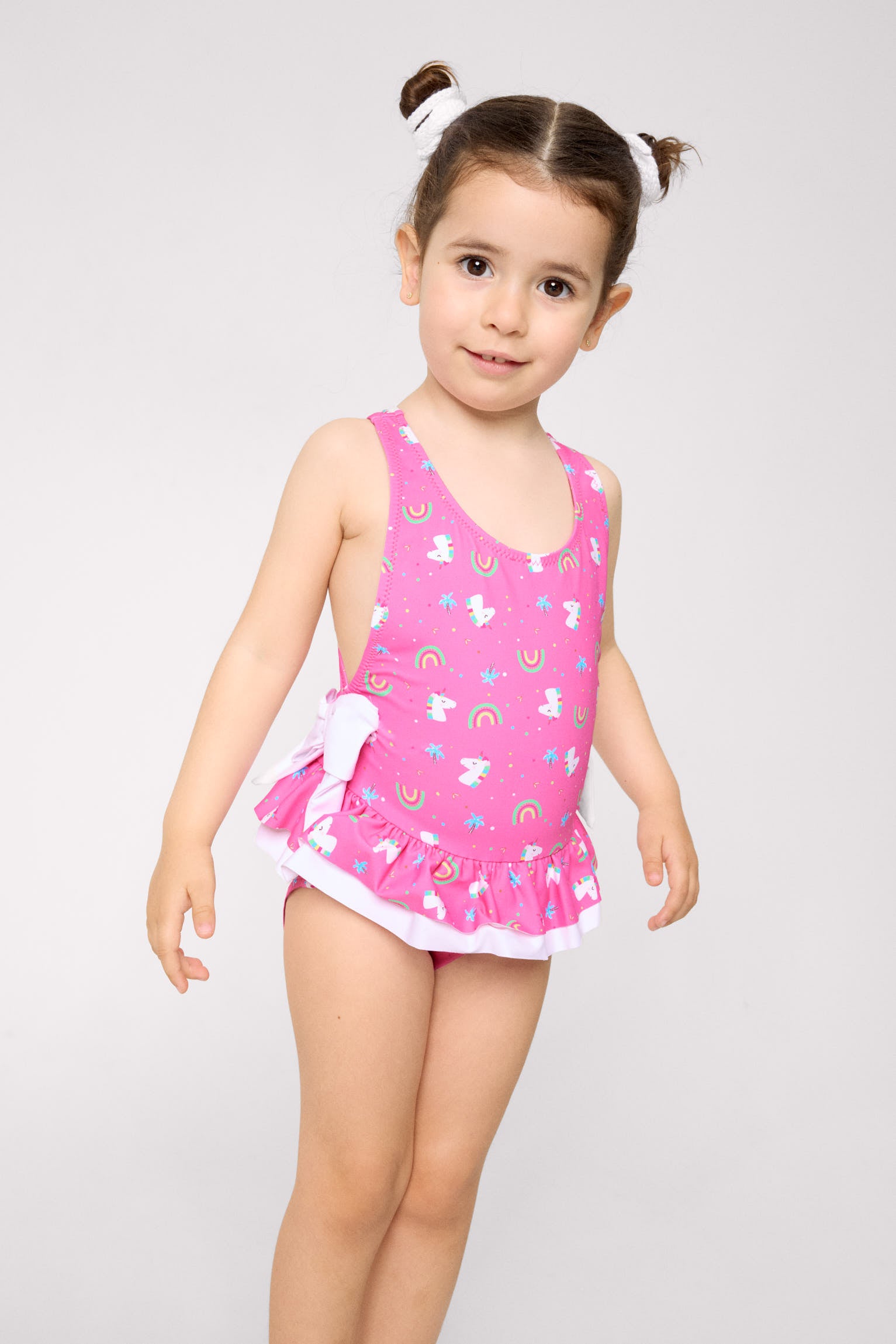 Girls' swimsuit with ruffle details and bows, unicorn print