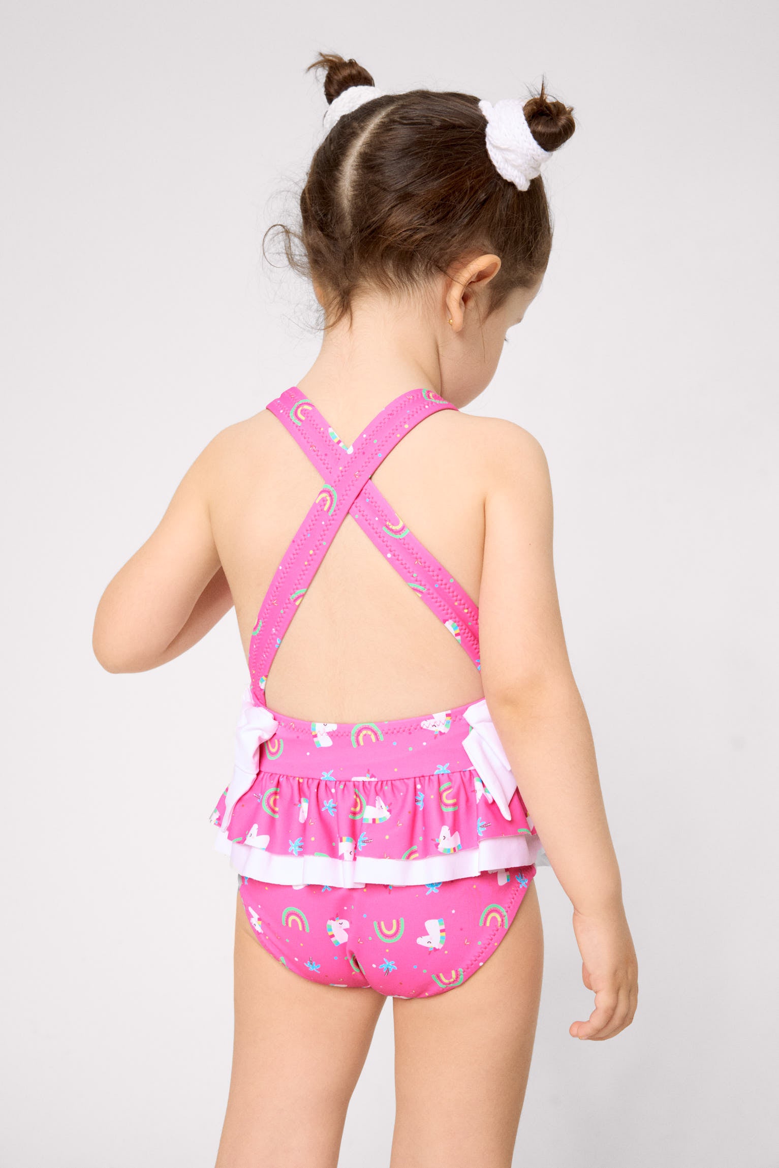 Girls' swimsuit with ruffle details and bows, unicorn print