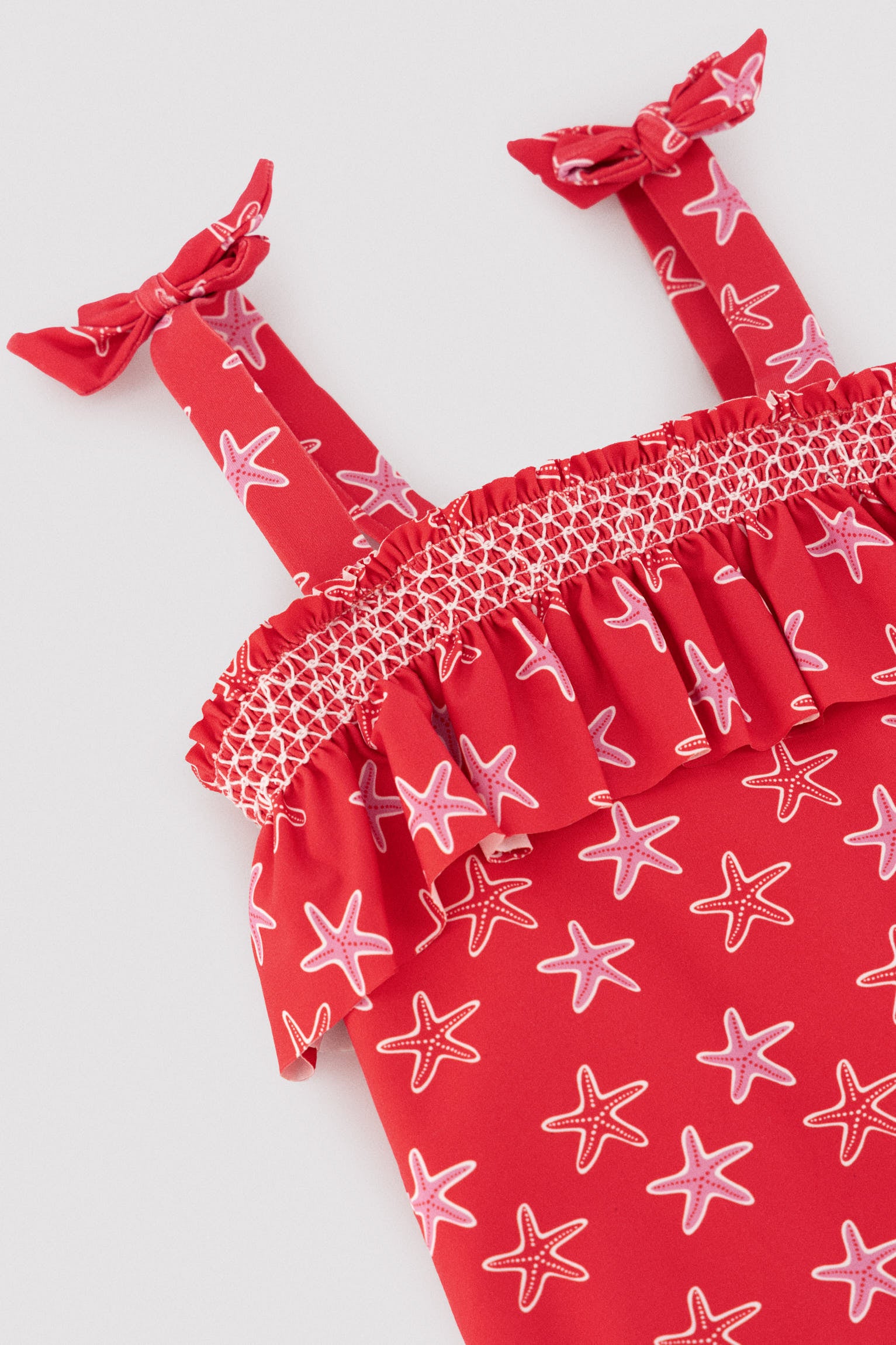 Girls' swimsuit with starfish print ruffle detail