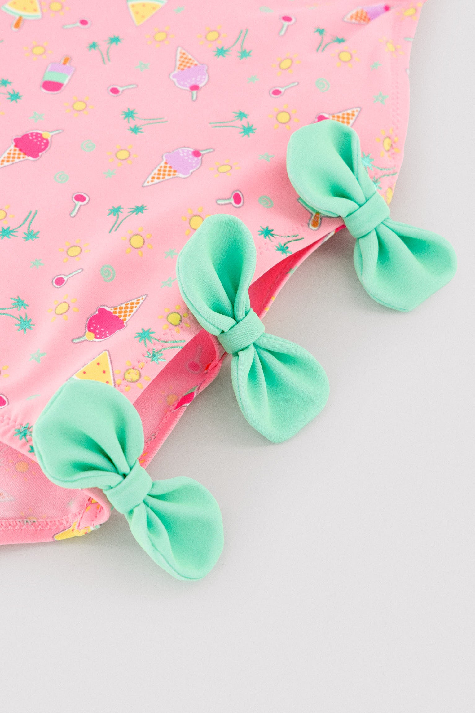Girls' swimsuit with cut-out detail and bows, summer print